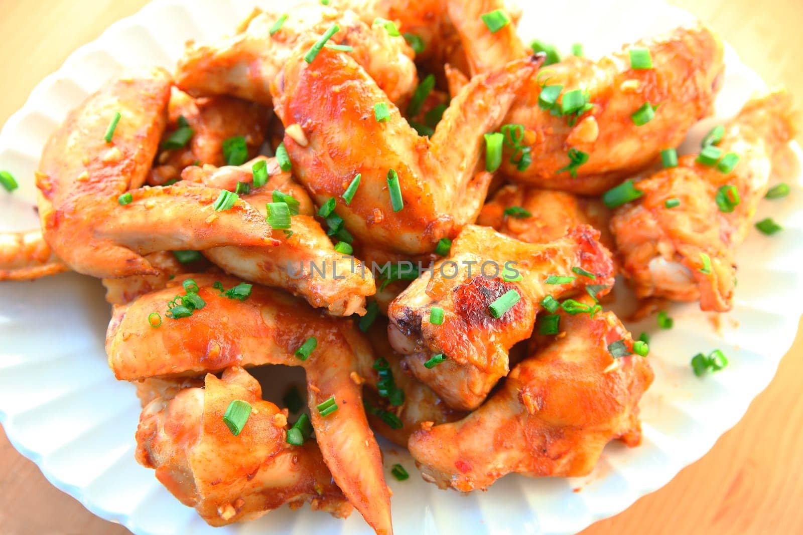 Platter of chicken wings garnished with scallions