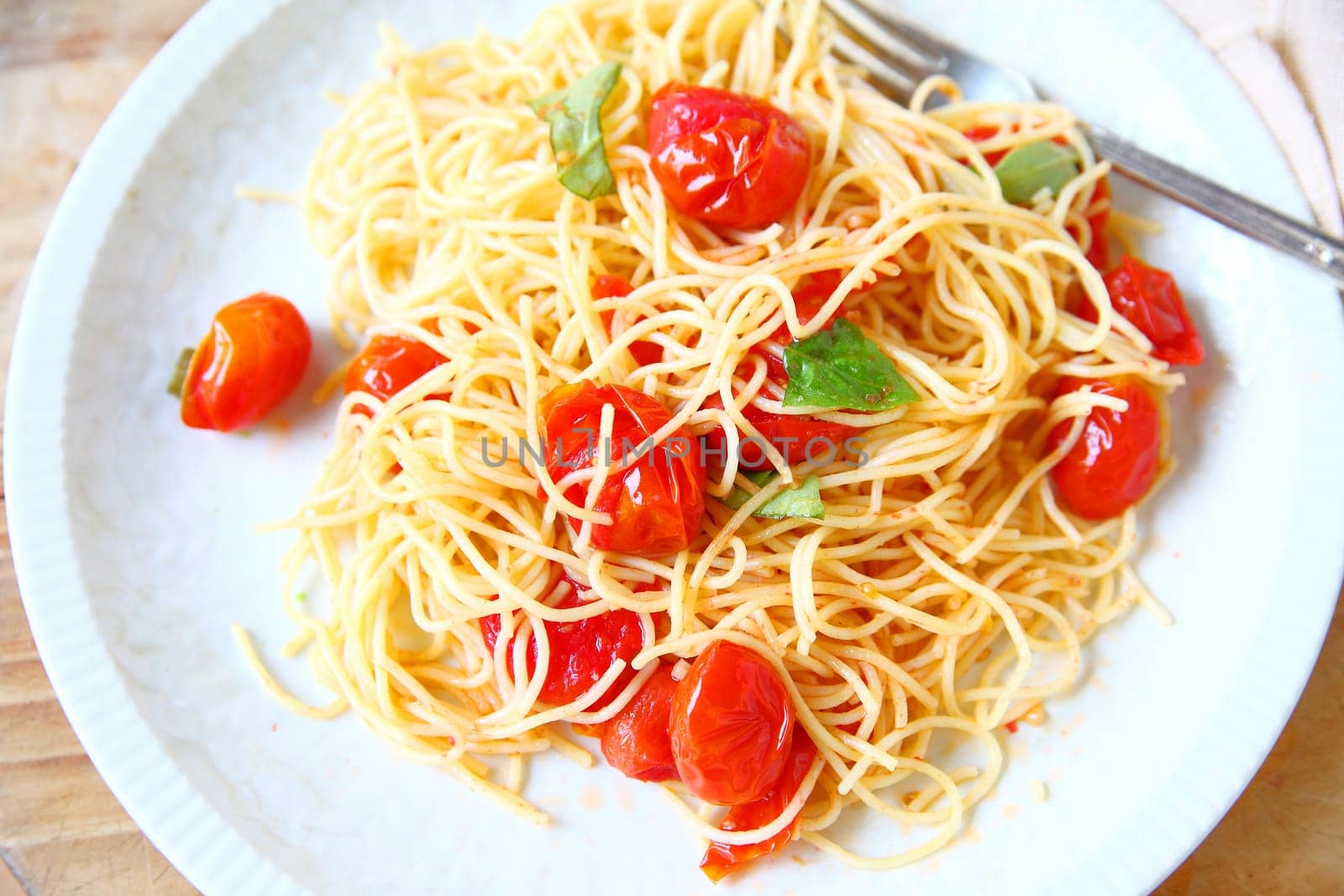 Vermicelli in a simple sauce of cherry tomatoes, olive oil, garlic and basil