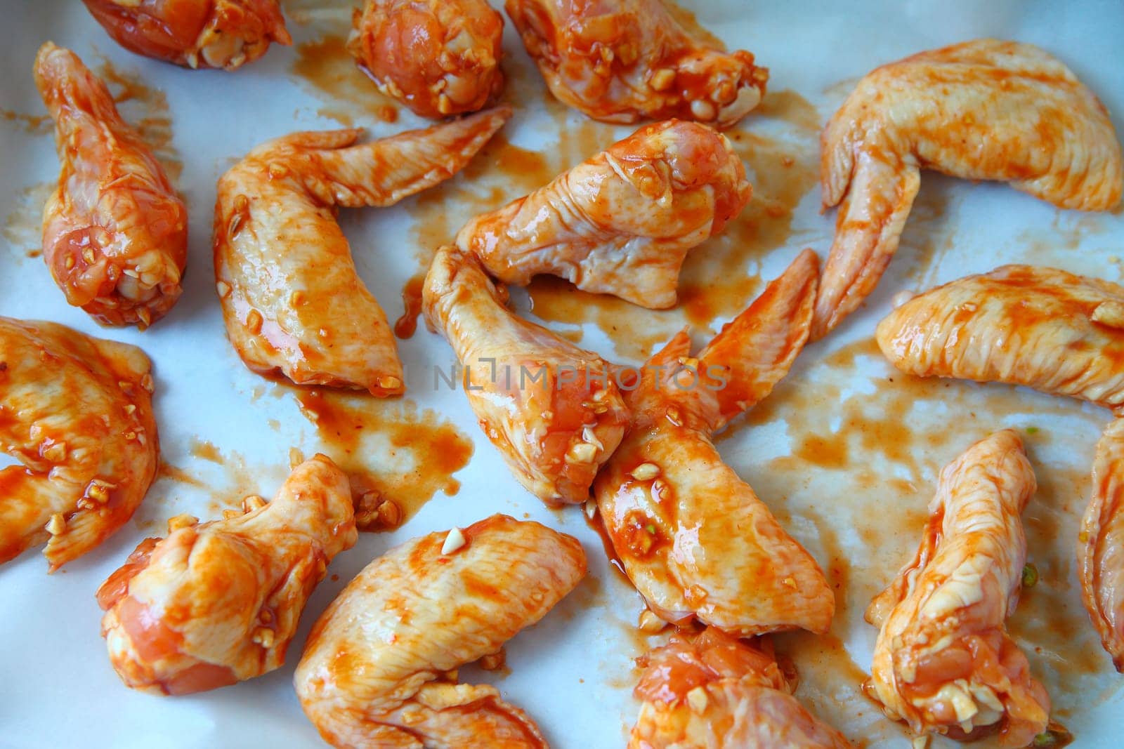Chicken wings on parchment covered pan ready to bake