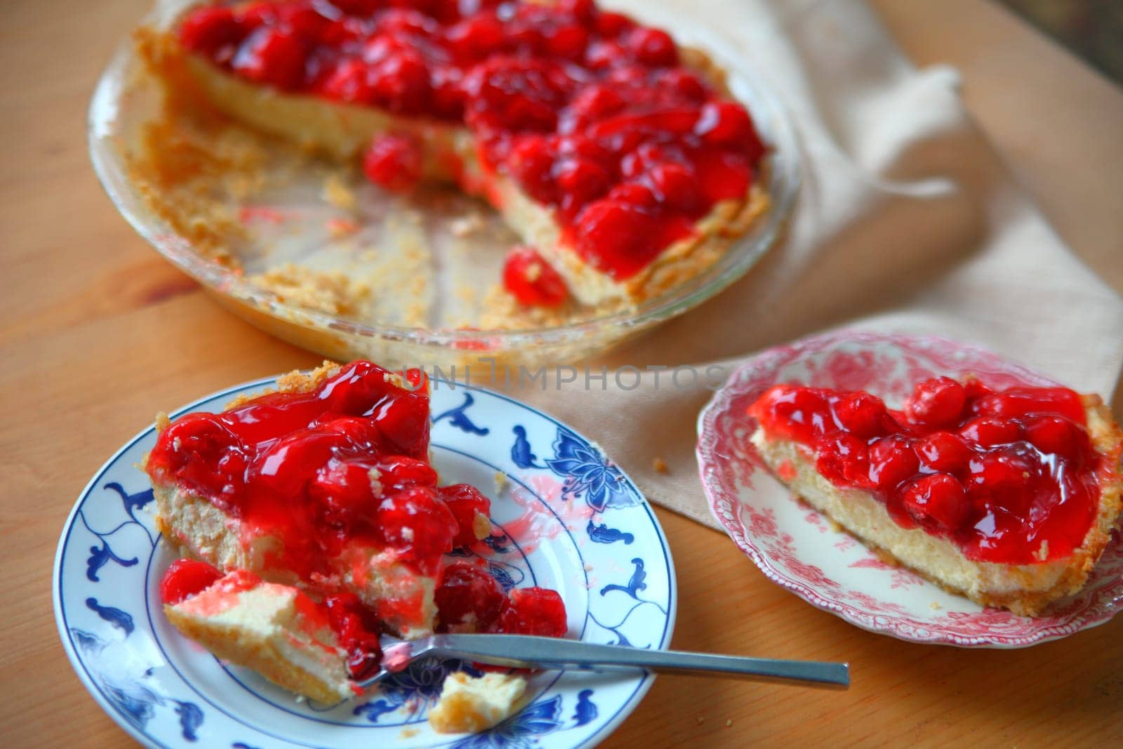 A cherry cream cheese pie served on decorative dishes