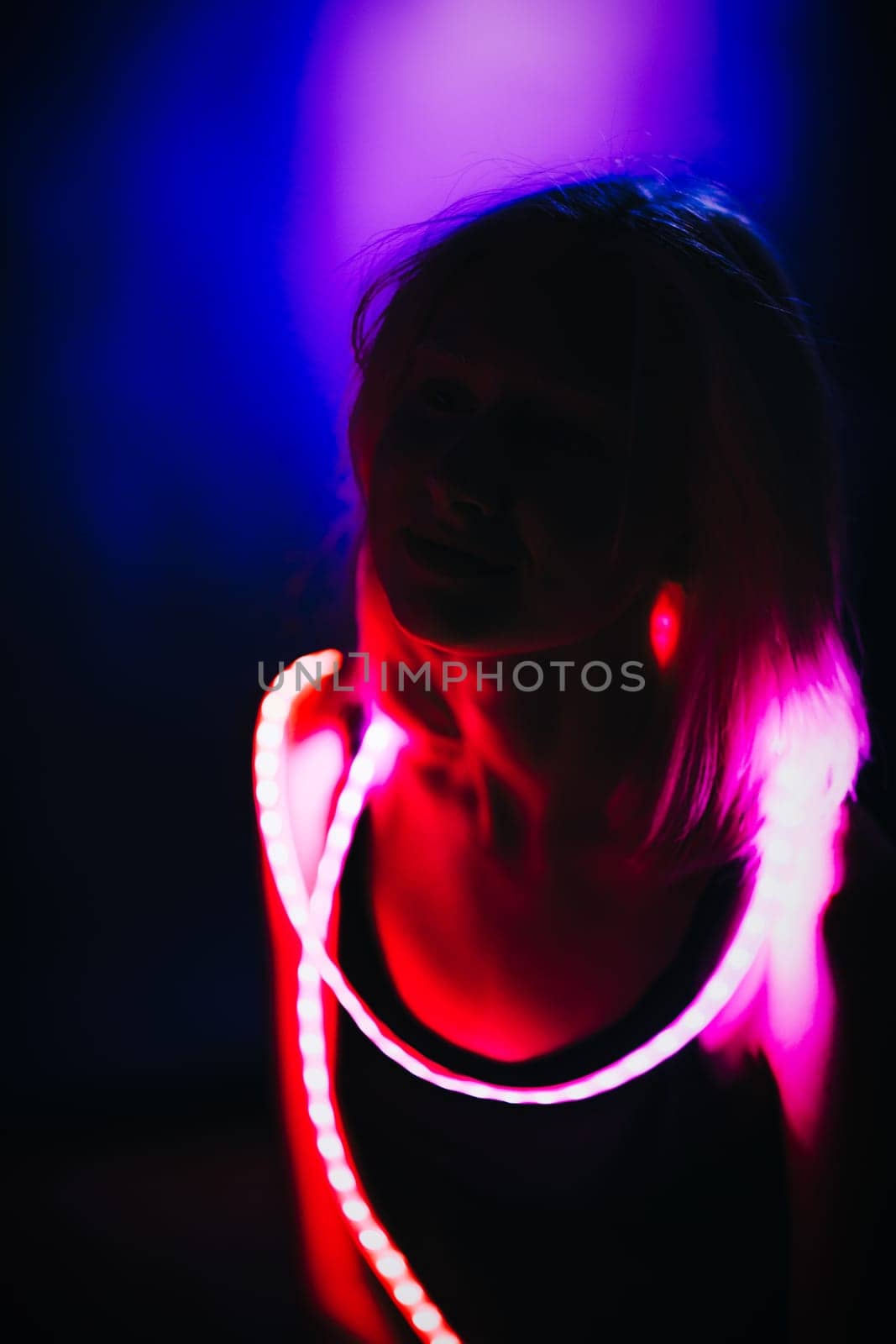 Portrait girl Strip Light LED tape on dark color background.