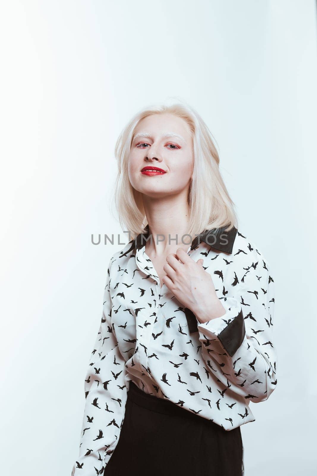 portrait blonde albino girl in studio on white background.