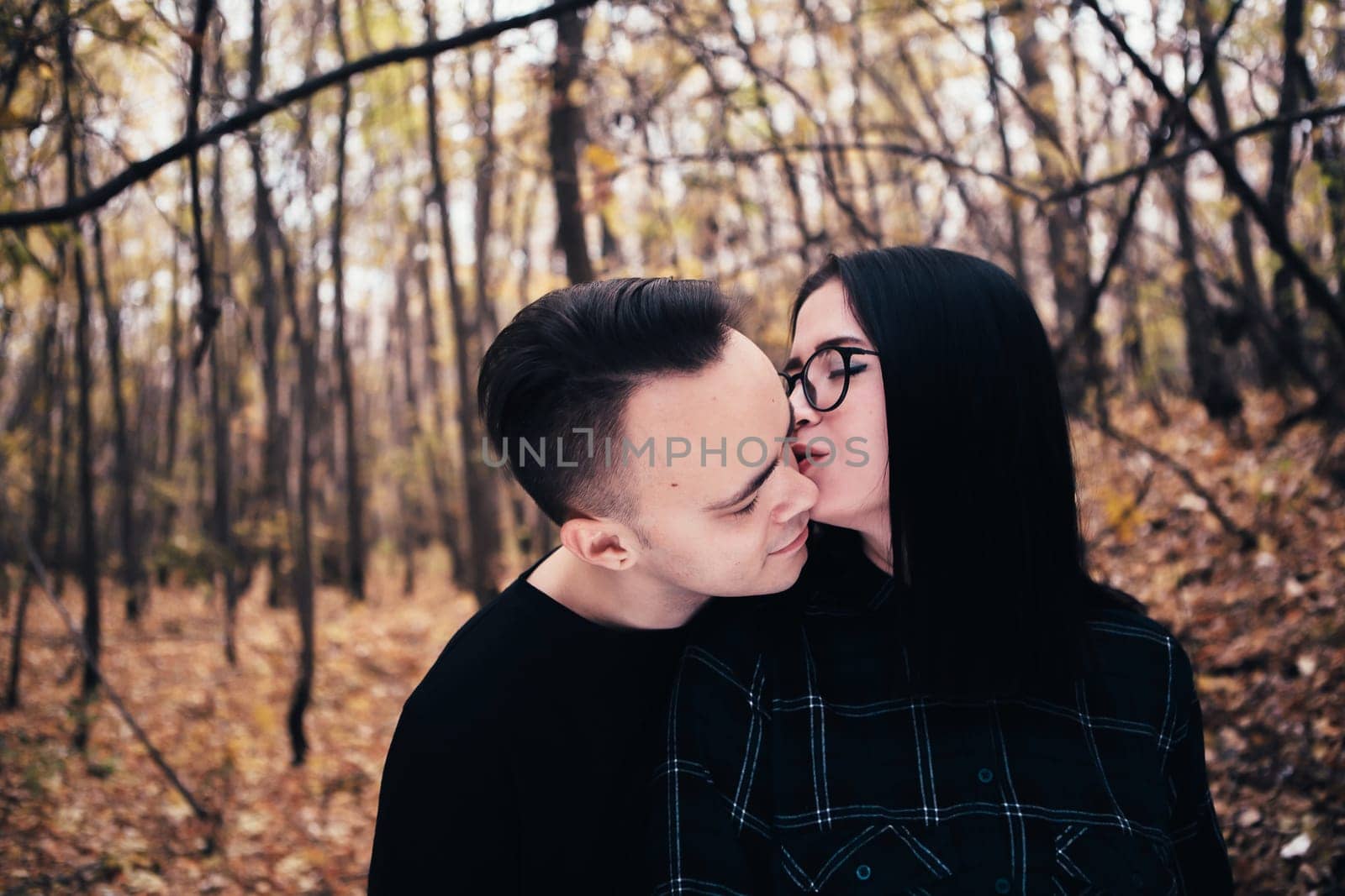 man and woman in the autumn forest