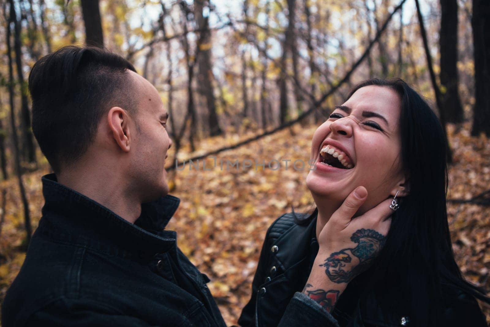 portrait of a young woman and a man walking in the autumn forest.