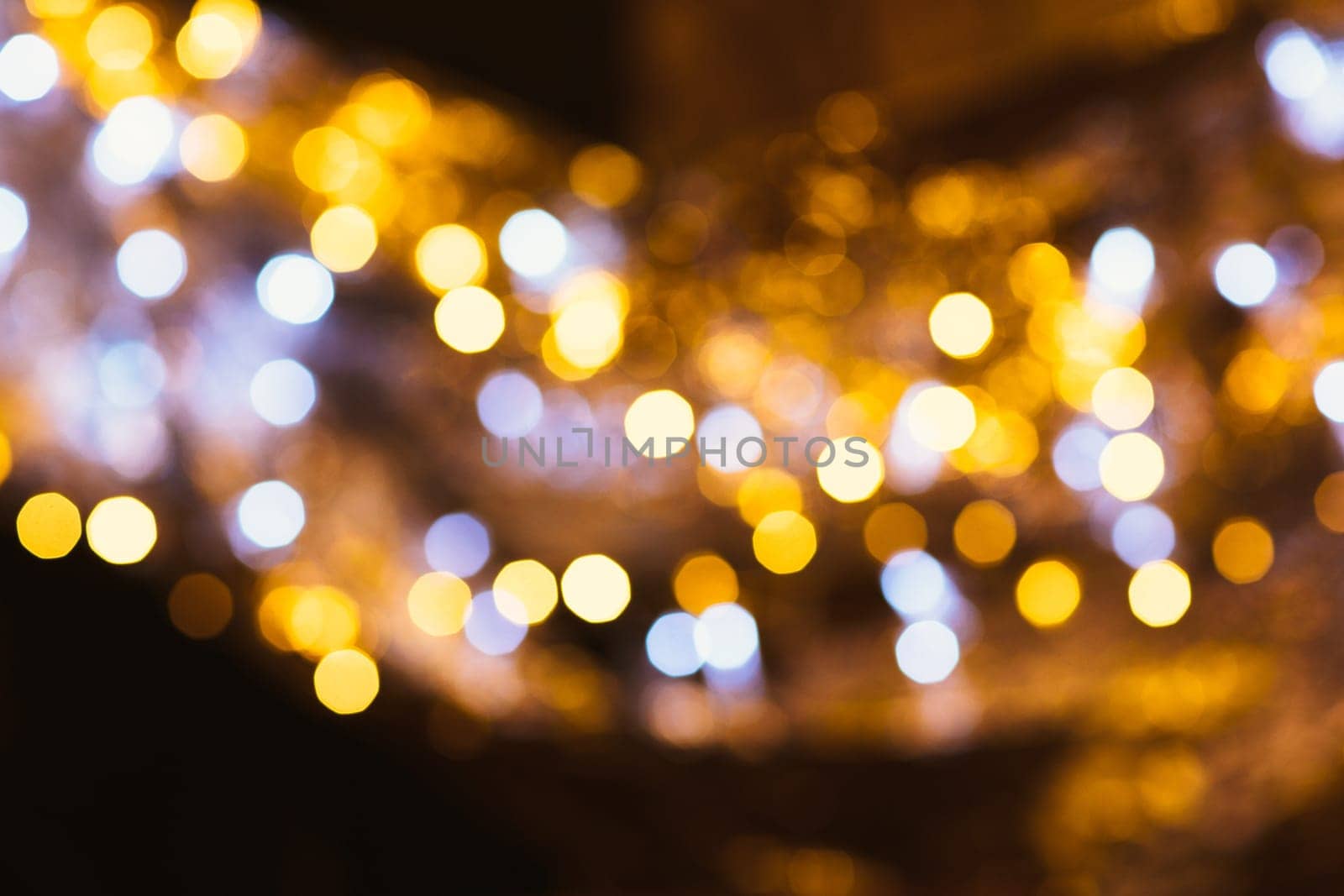 gold and silver bokeh on a dark background.