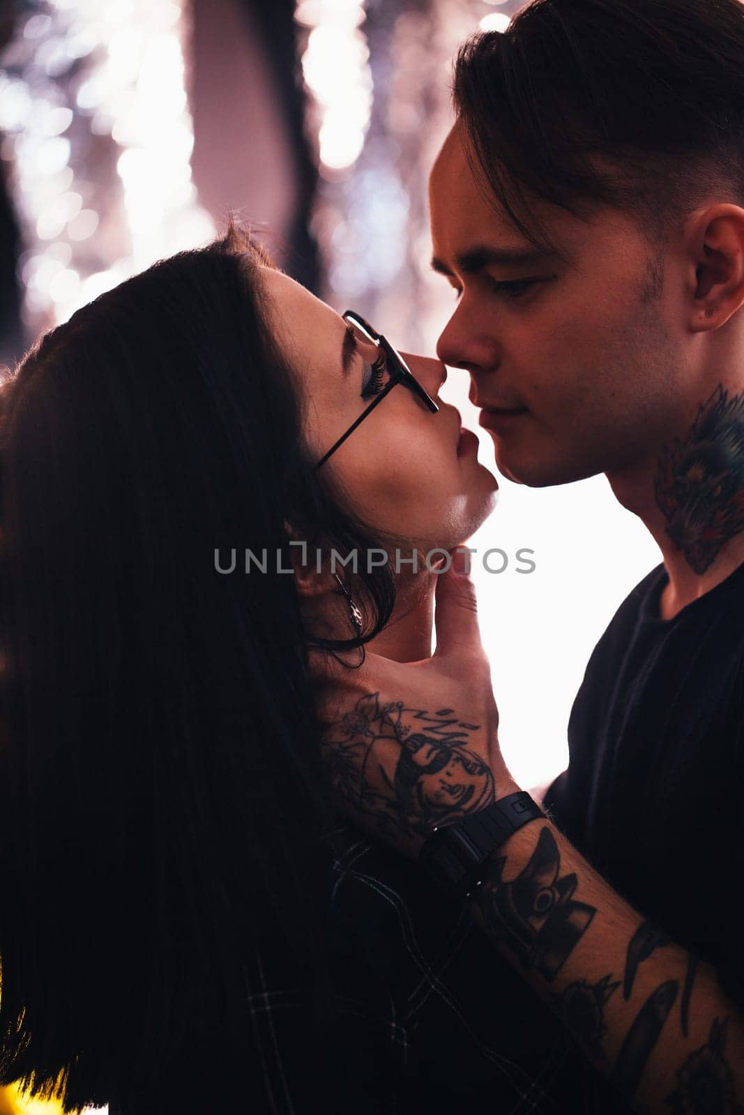 guy and the girl kiss closeup on a light background