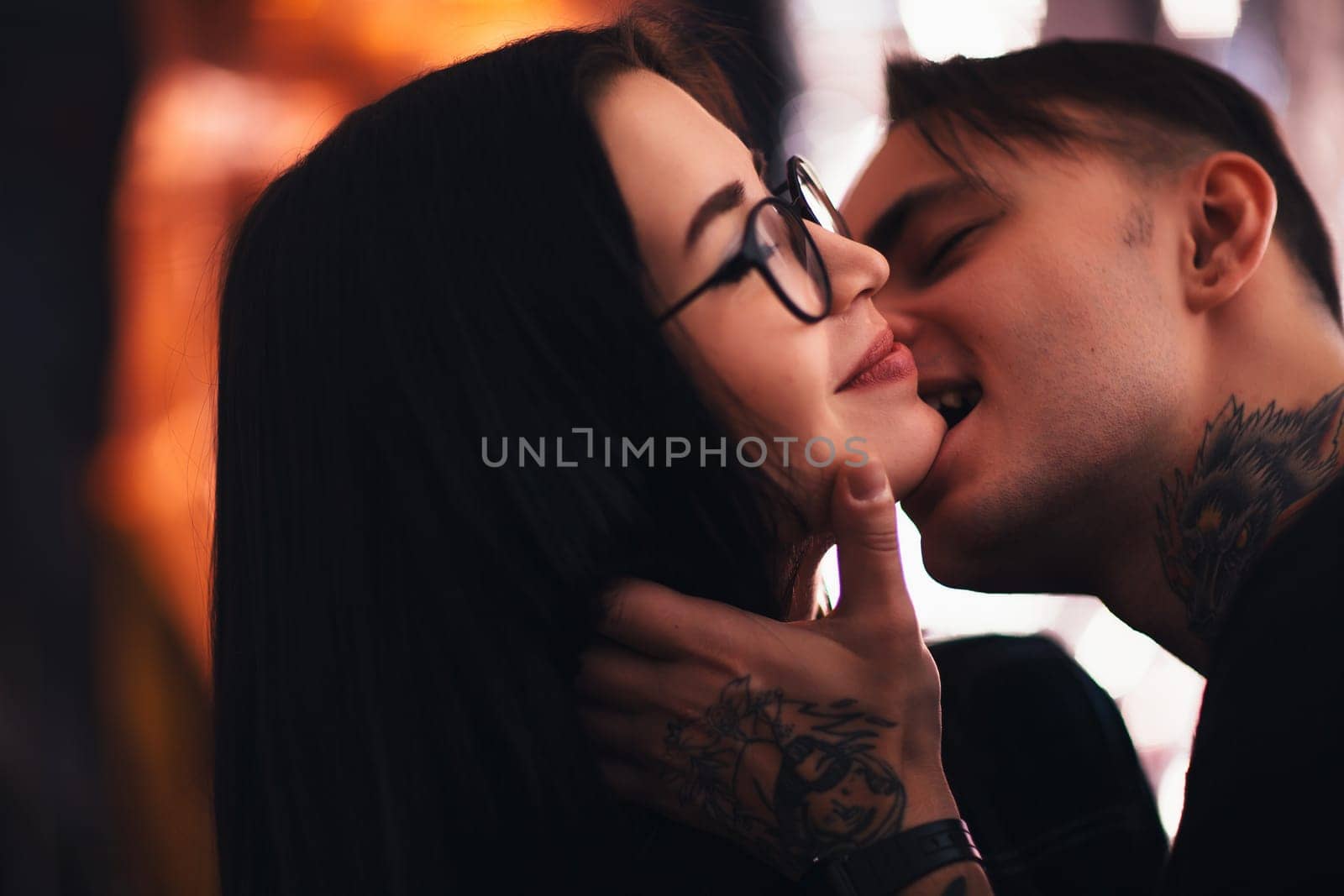 guy and the girl kiss closeup on a light background