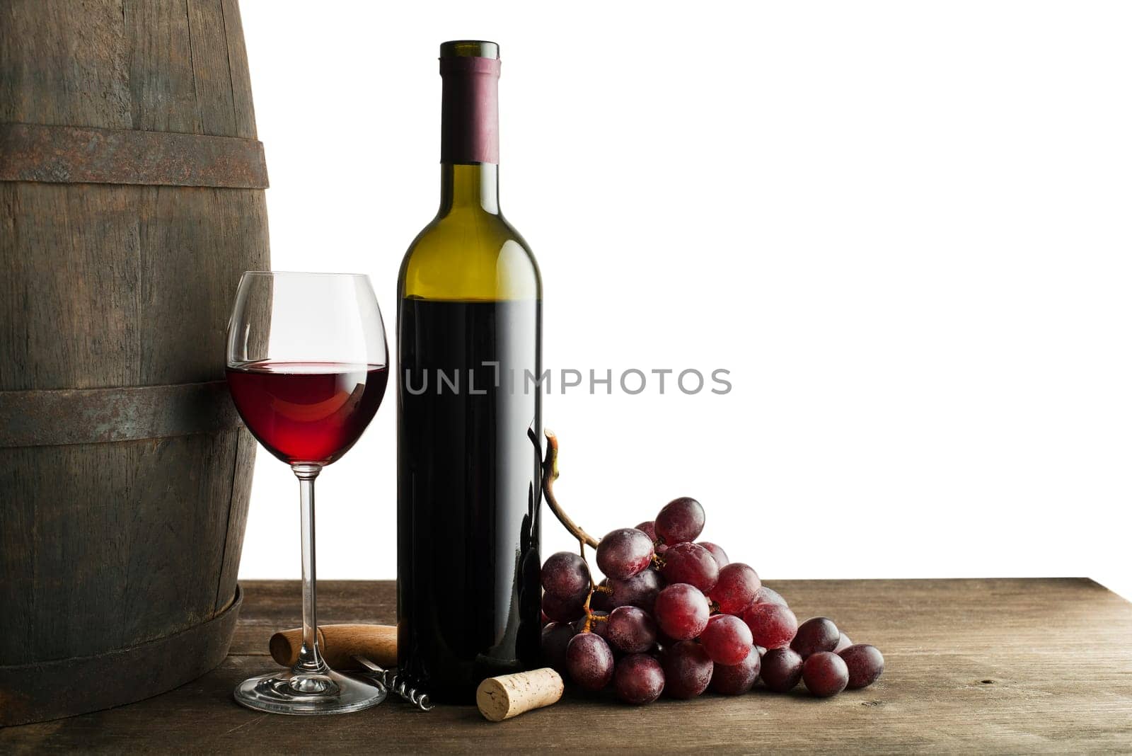 Glass and bottle of red wine with wooden and barrel background isolated on white