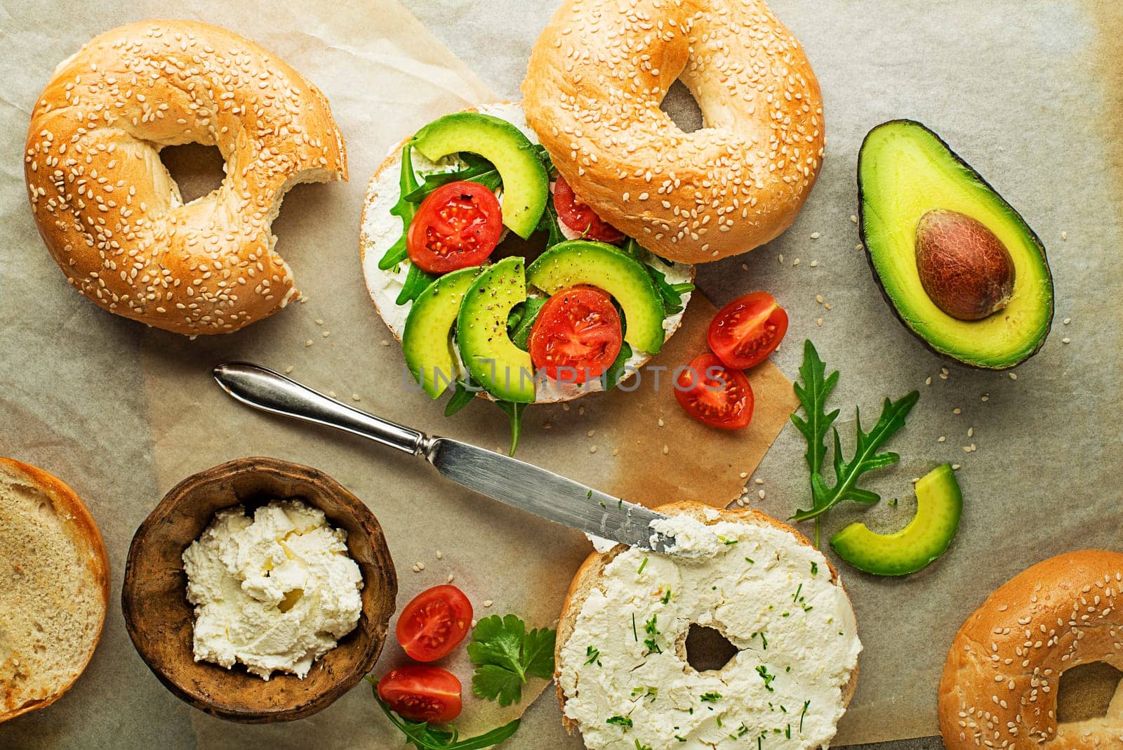 Vegetarian Bagel sandwich with cheese cream, avocado and tomato. Healthy vegetarian and vegan food.