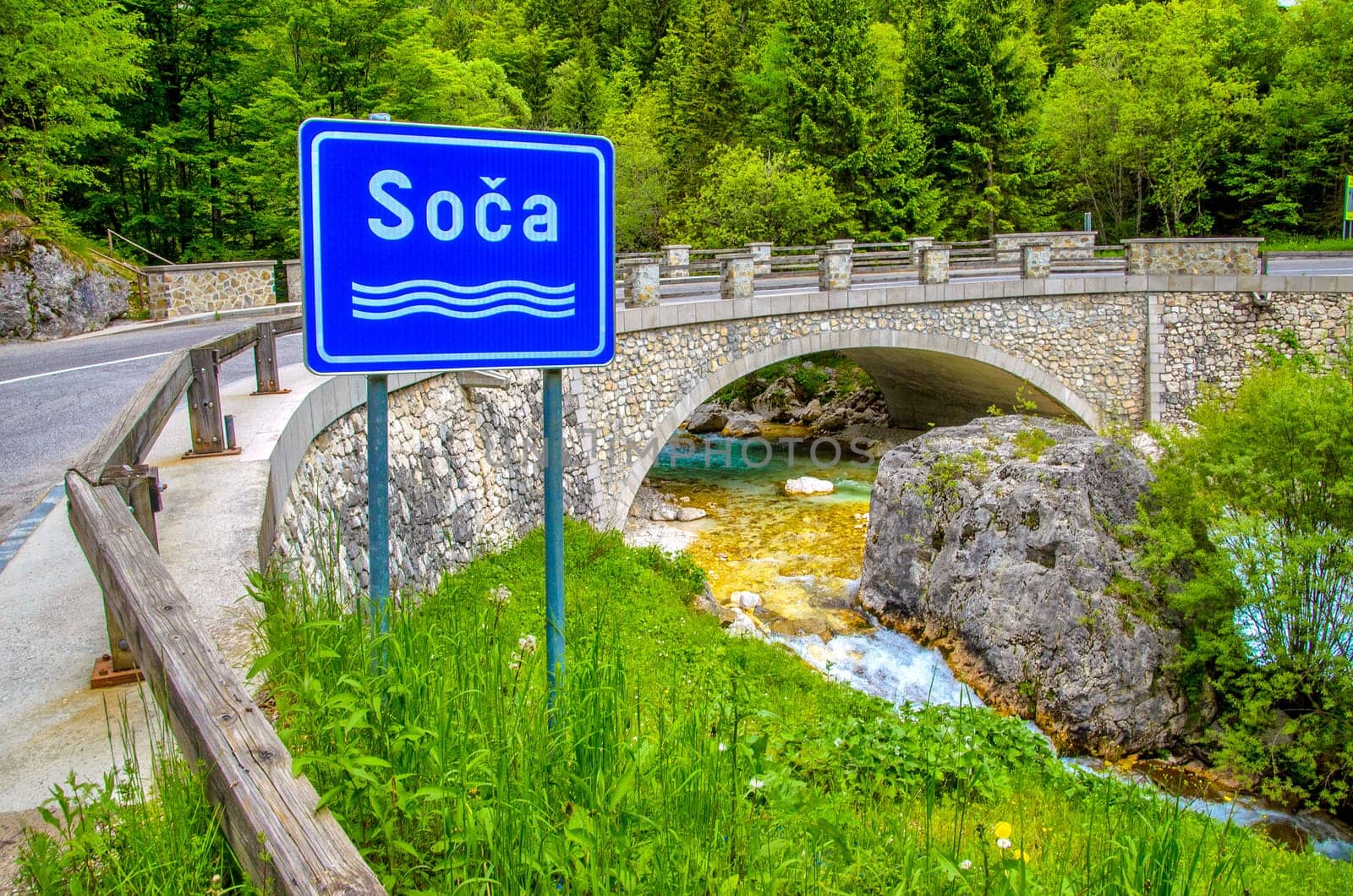 The Soca or Isonzo river sign in Slovenia - Triglav National Park .