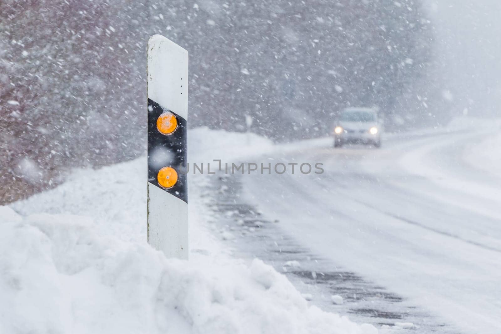 The street track is slick and frozen. High dangerous risk of an accident through the blizzard snowstorm and severe weather at christmas time season.