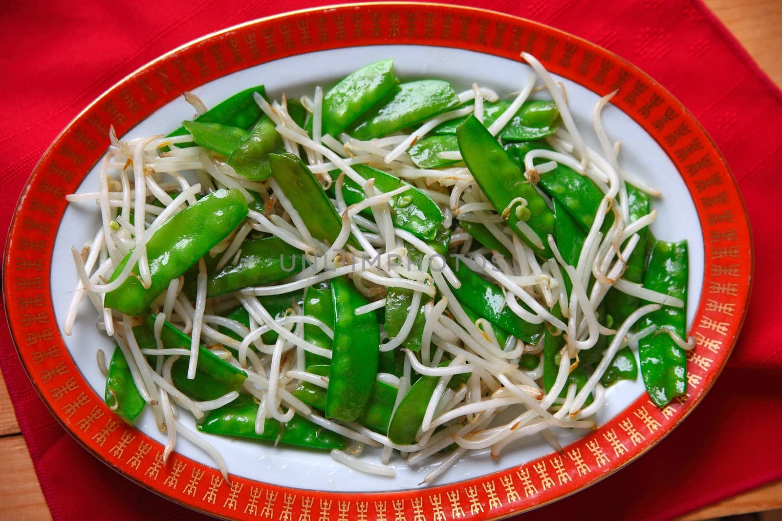 Overhead view of vegetable dish on decorative dinnerware
