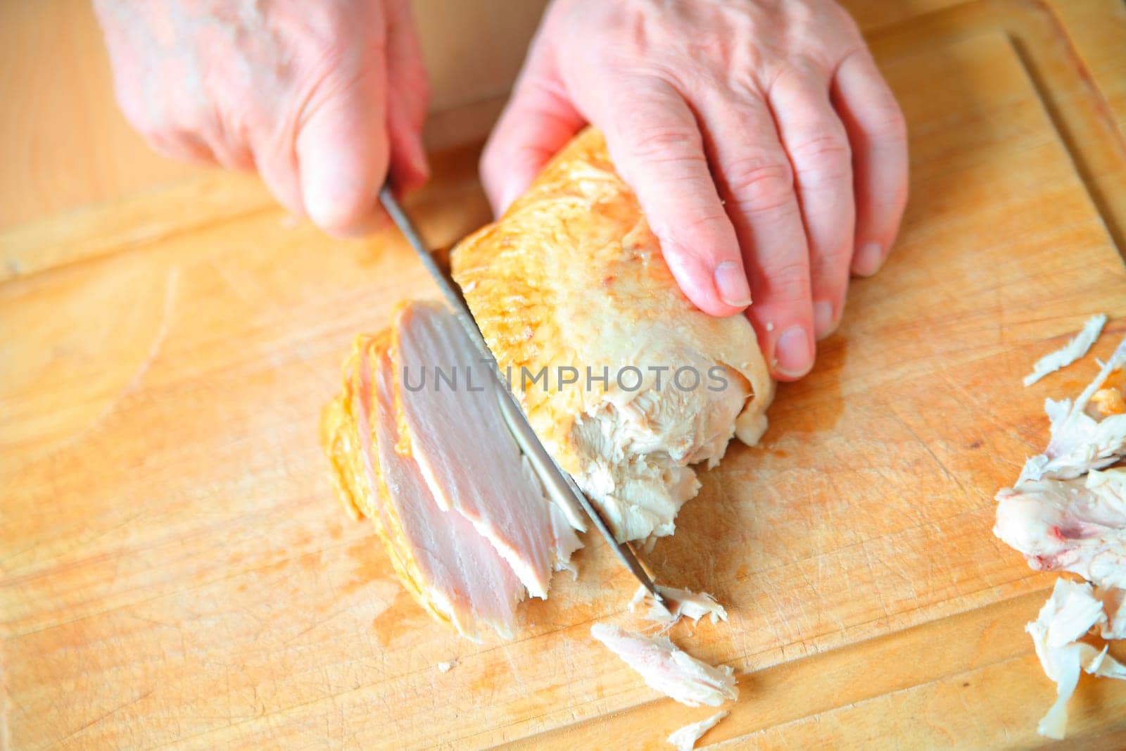 A man slicing roast turkey breast