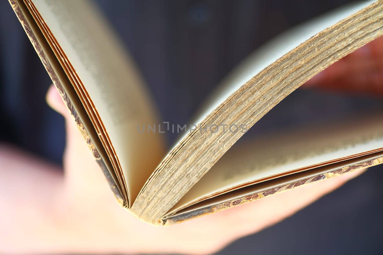 A vintage book held by man closeup