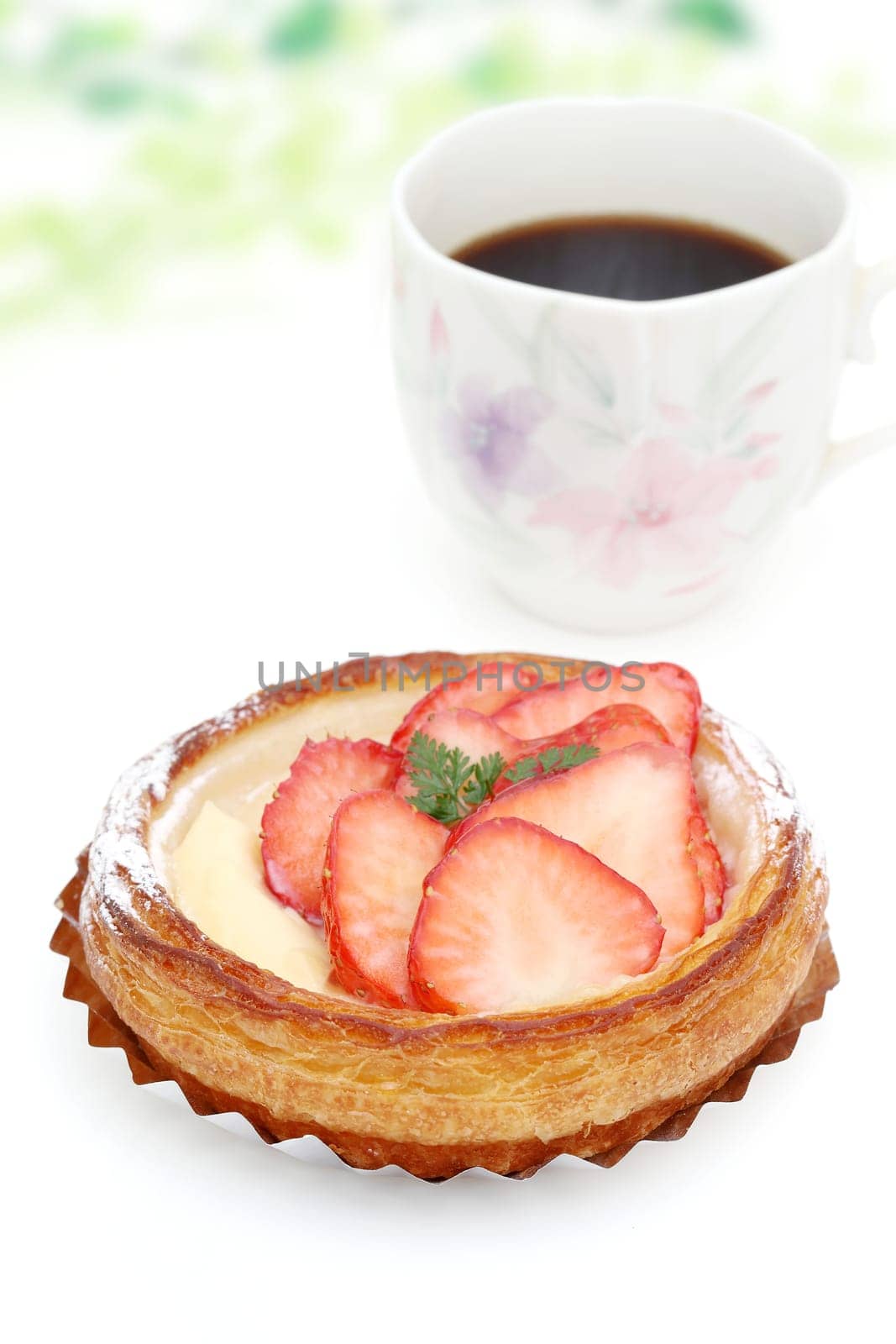 strawberry danish bread and cup of coffee for breakfast