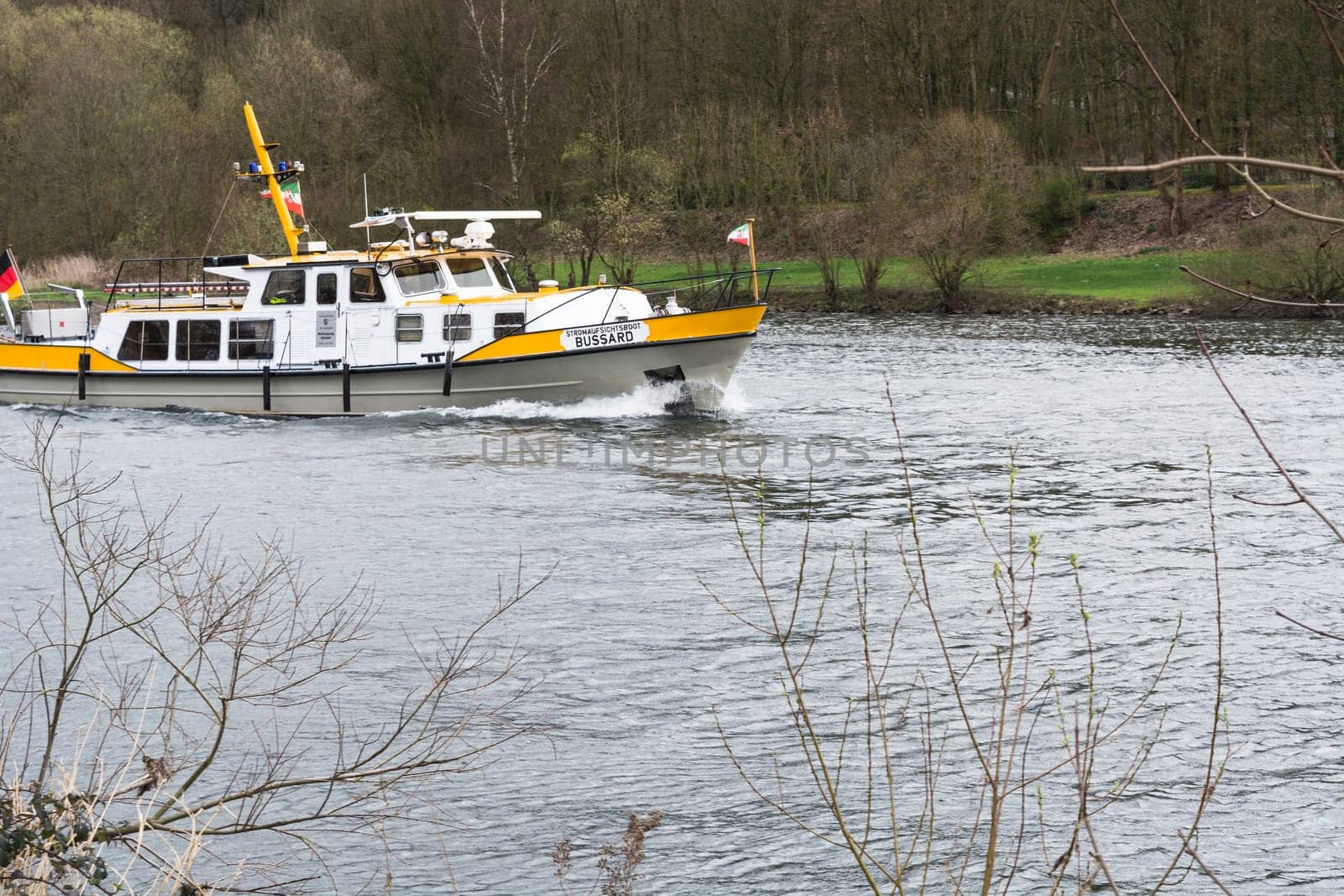 ESSEN, NRW, GERMANY - APRIL 4, 2016:.River supervisor boat Bussard MS at a check ride on the river Ruhr in Germany. Boat in use for water protection..