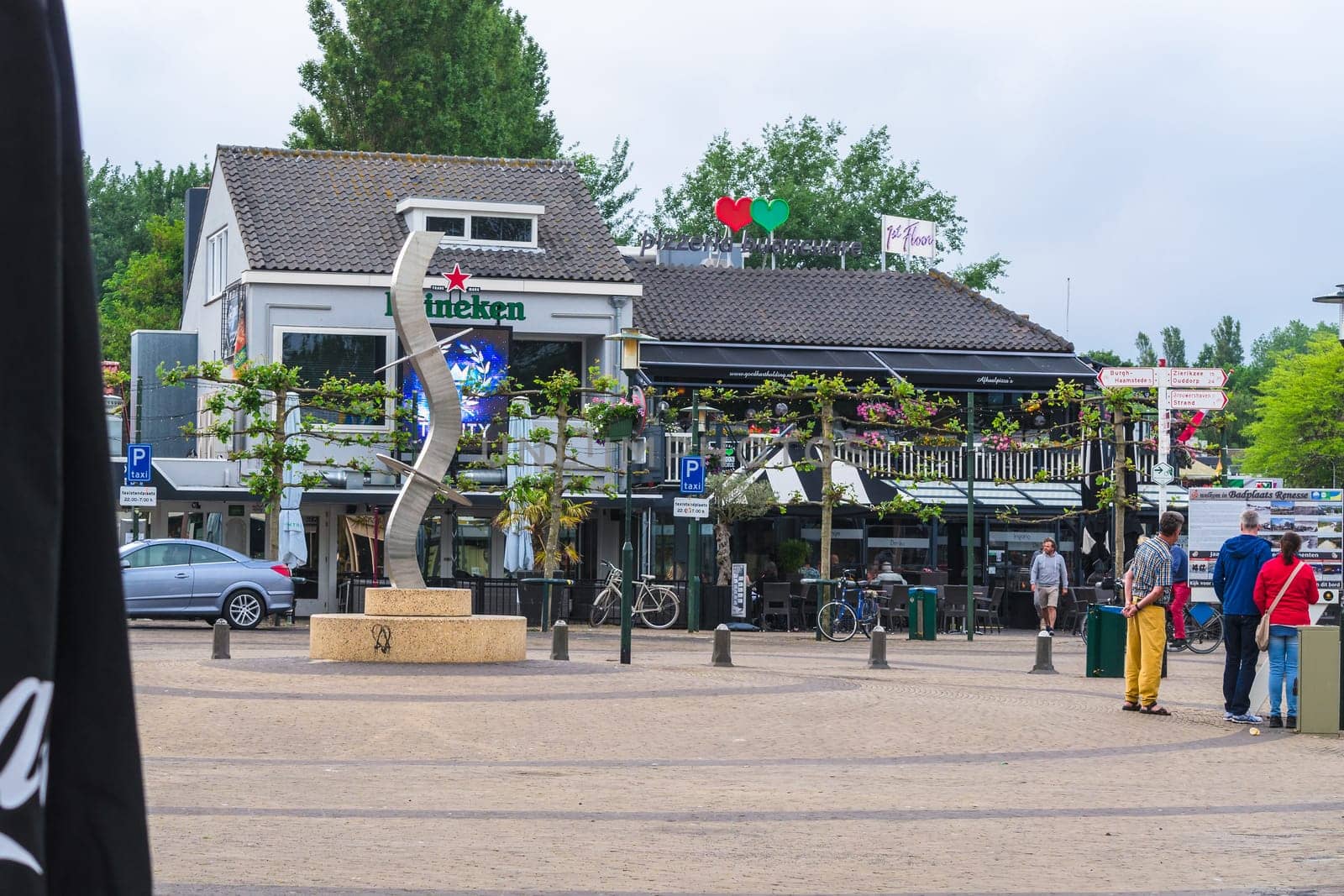 RENESSE, ZEELAND, THE NETHERLANDS - JUNE 14 2015:.Renesse city center on the main street overlooking a restaurant.