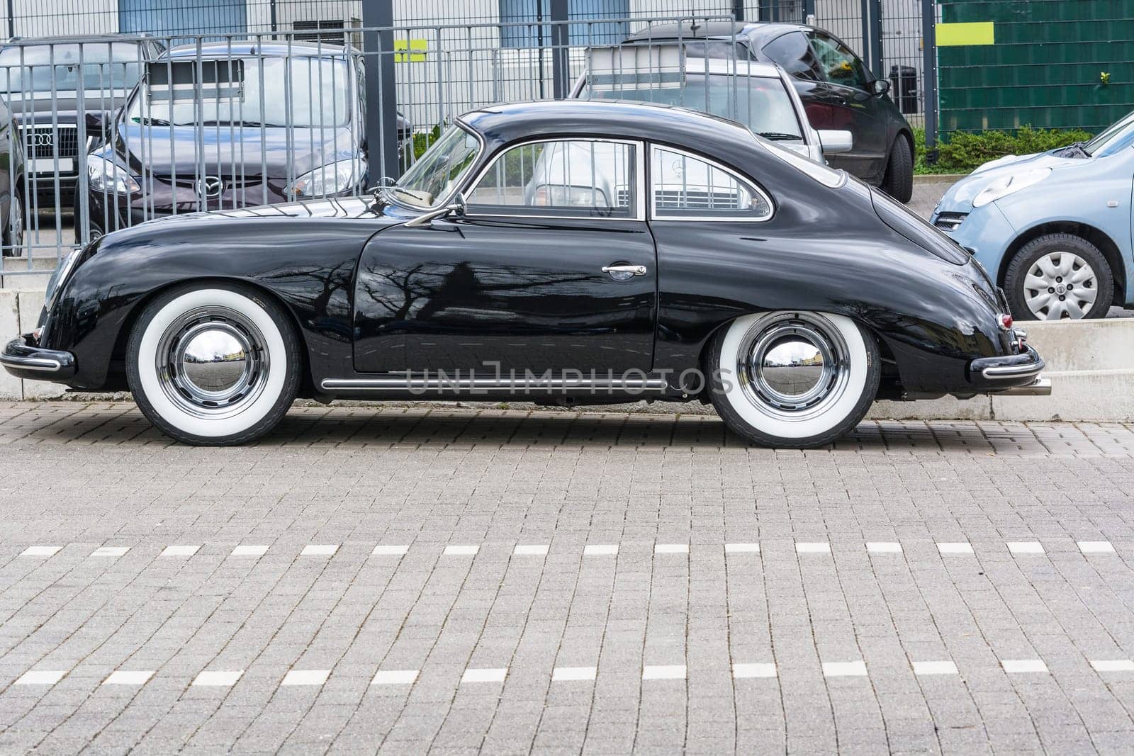 VELBERT, NRW, GERMANY - APRIL 06, 2016:.Black vintage Porsche 1600 with whitewall tires on a car park in Velbert city center, Germany...