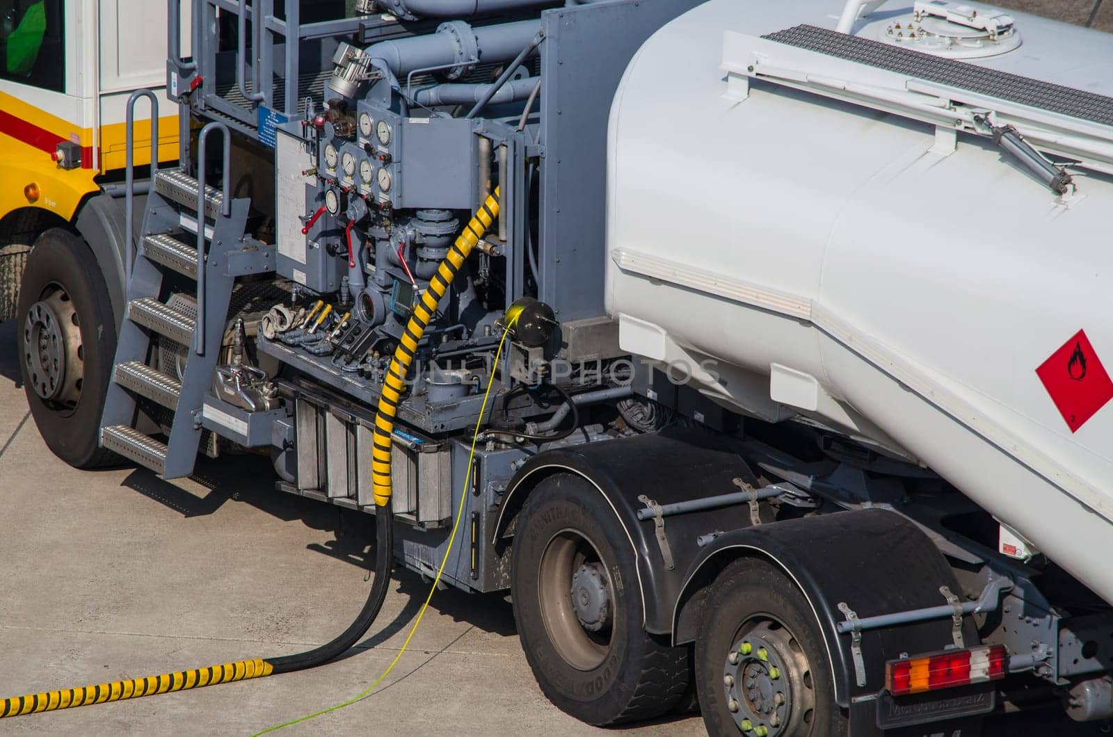 DUESSELDORF, NRW, GERMANY - MARCH 18, 2015: Aviation fuel truck on during refueling of an aircraft at Duesseldorf Airport in Germany.