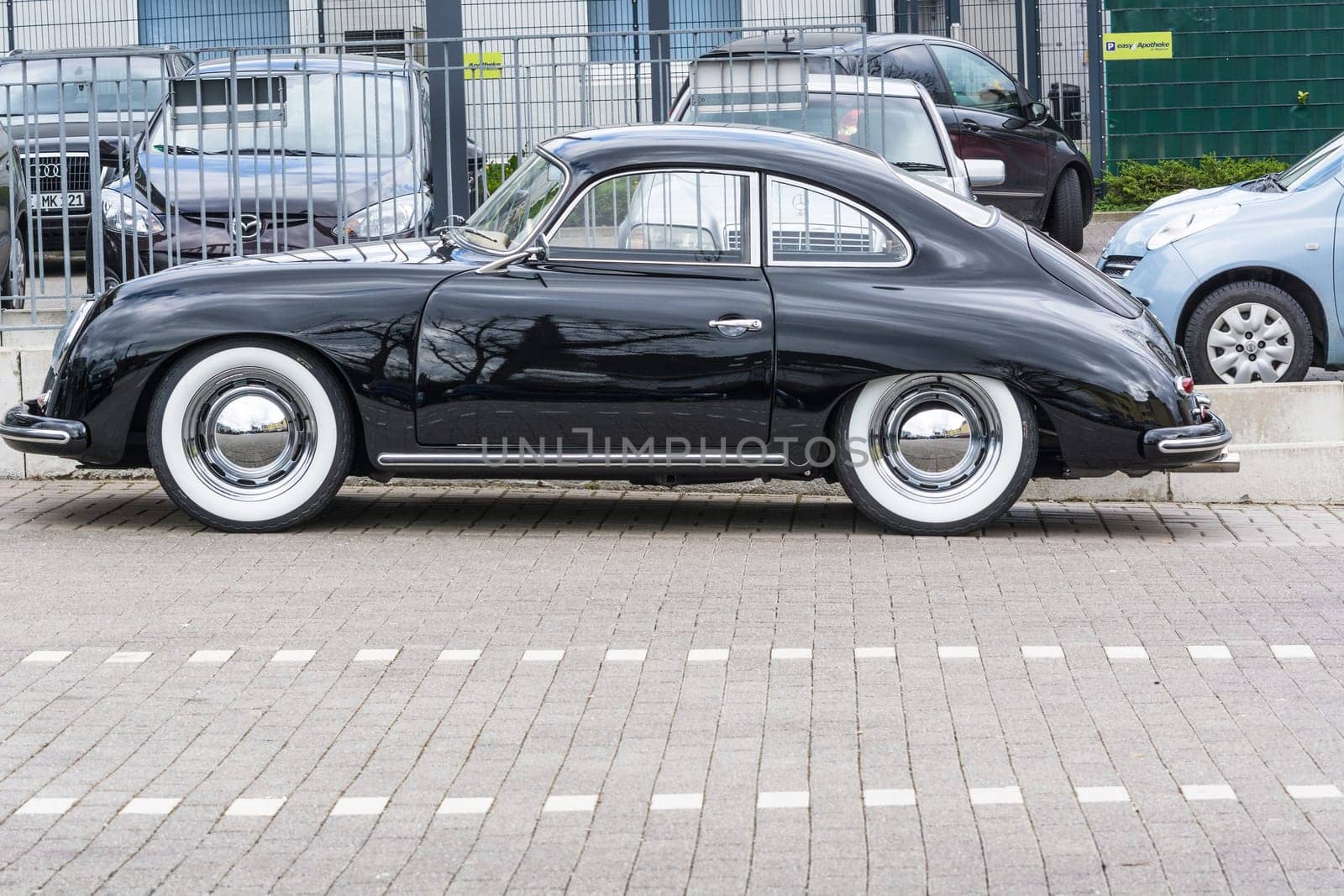 VELBERT, NRW, GERMANY - APRIL 06, 2016:.Black vintage Porsche 1600 with whitewall tires on a car park in Velbert city center, Germany...