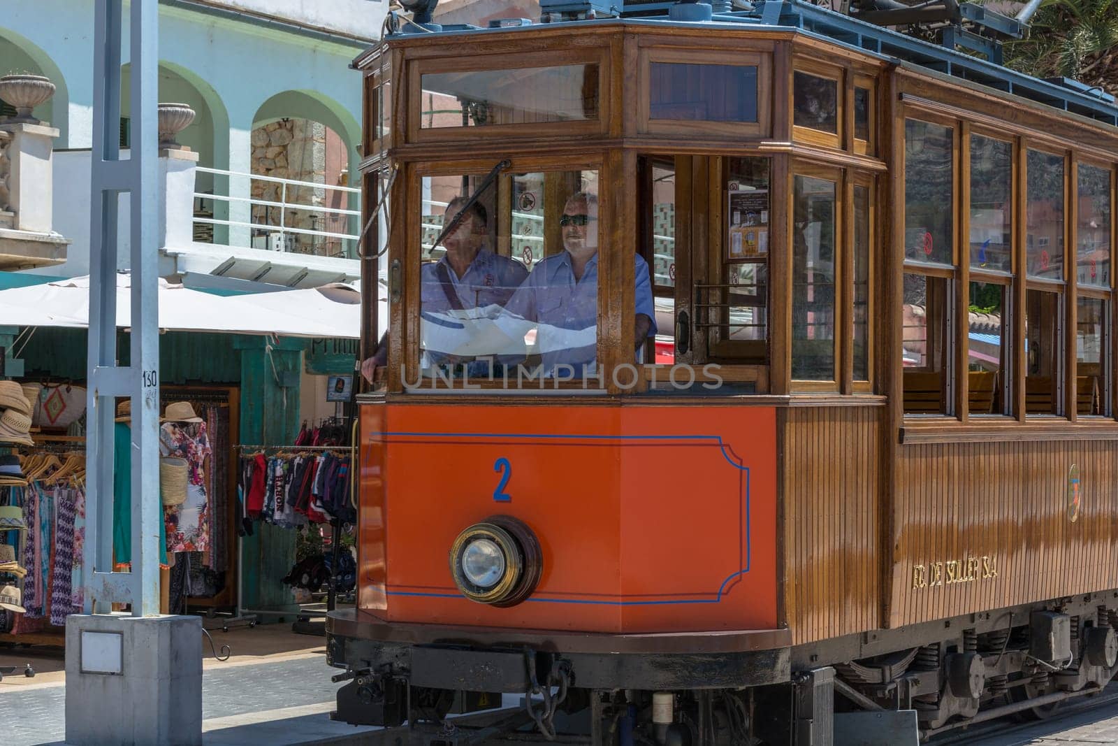 PORT DE SOLLER, SPAIN - JUNE 02, 2016: Vintage train, tram on the beach promenade of the town of Soller in Spain. Opened in 1913, the driving distance is about 5 km long.