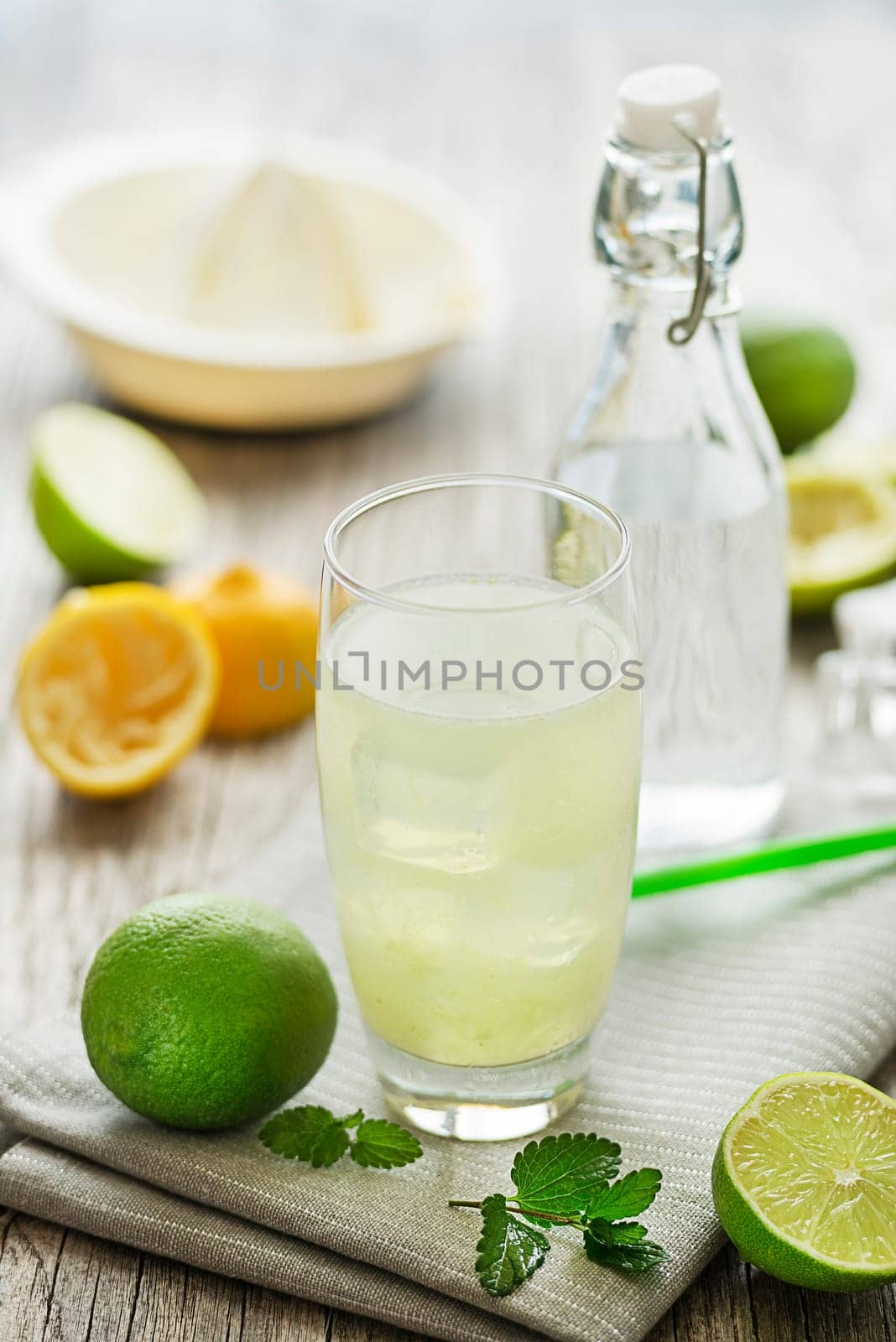 Lemonade or juice with lemon and mint, cold refreshing drink or beverage with ice