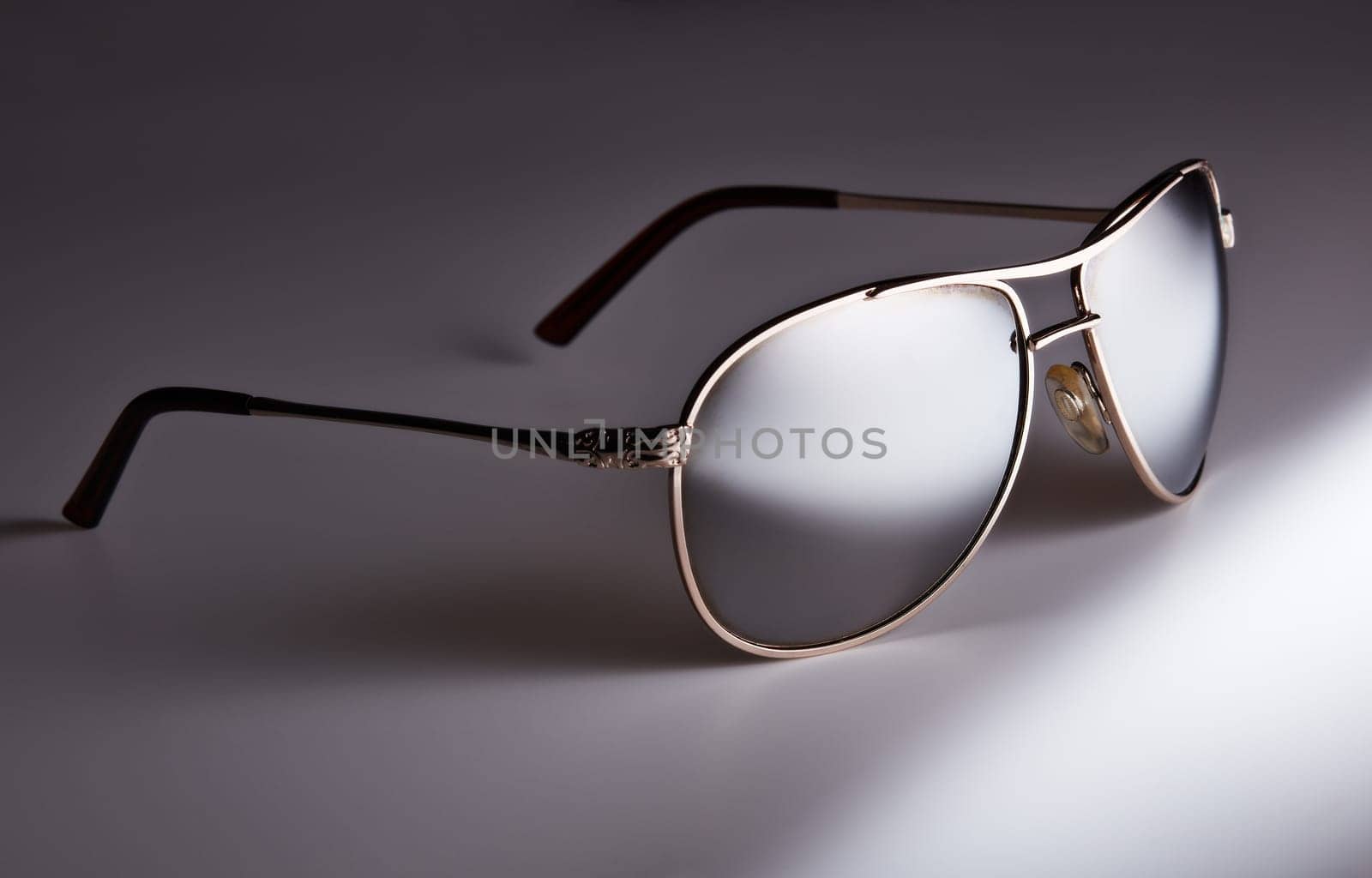 Sunglasses isolated on a white background. Classic design. Protection of eyes against the UV radiation of the sun