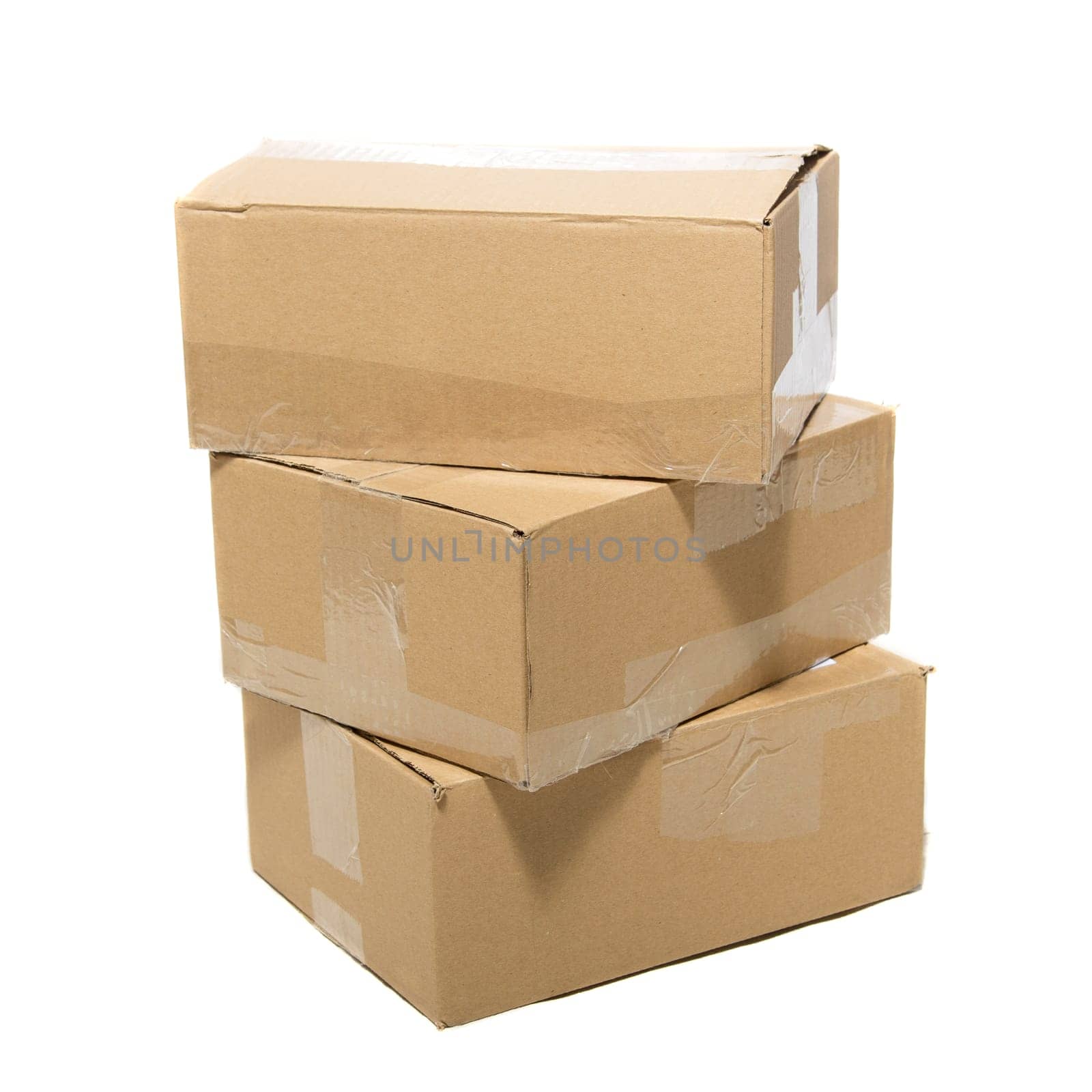 Three closed cardboard boxes packed with goods ready for shipping