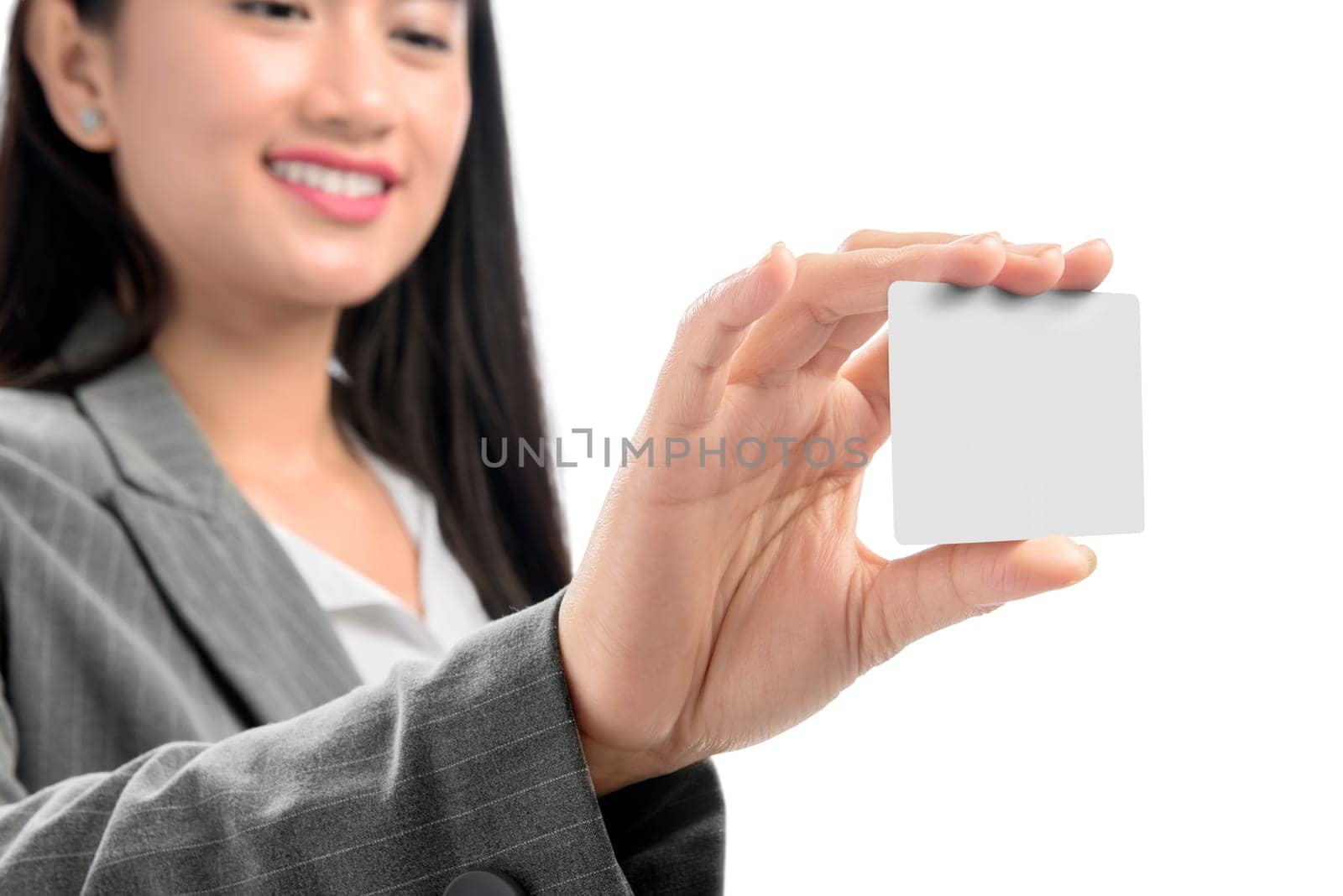 Pretty asian business woman showing blank business card on her hand standing isolated over white background