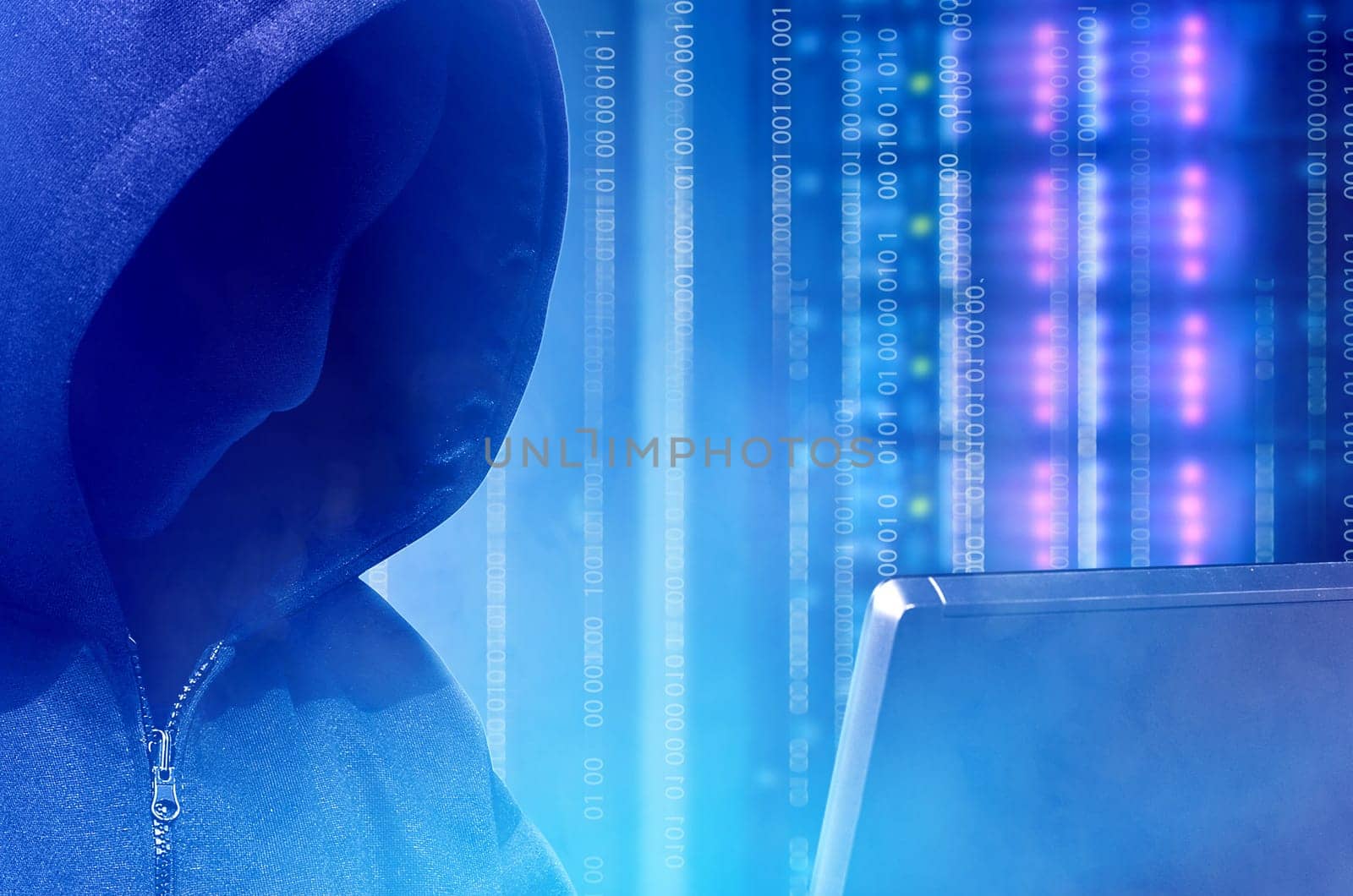 Close up view of hacker in black hoodie holding laptop with binary code on virtual screen with modern storage of server in the data center on the background