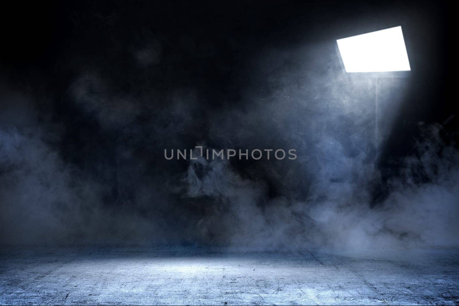 Room with concrete floor and smoke with light from spotlights against dark wall background