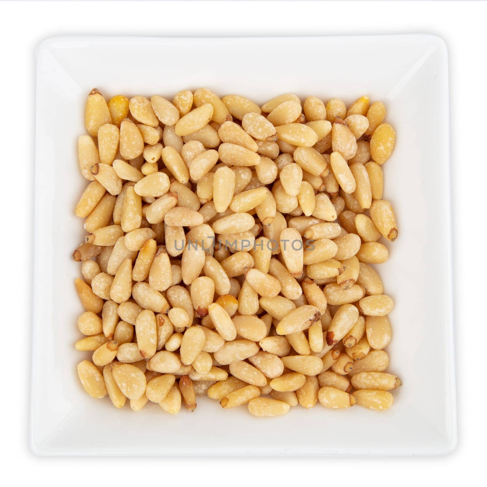Fresh Pine Nuts in a bowl isolated on white background