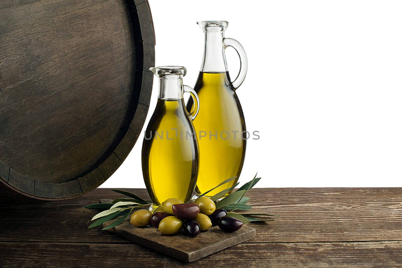 Bottles of Extra virgin healthy Olive oil with barrel background on white