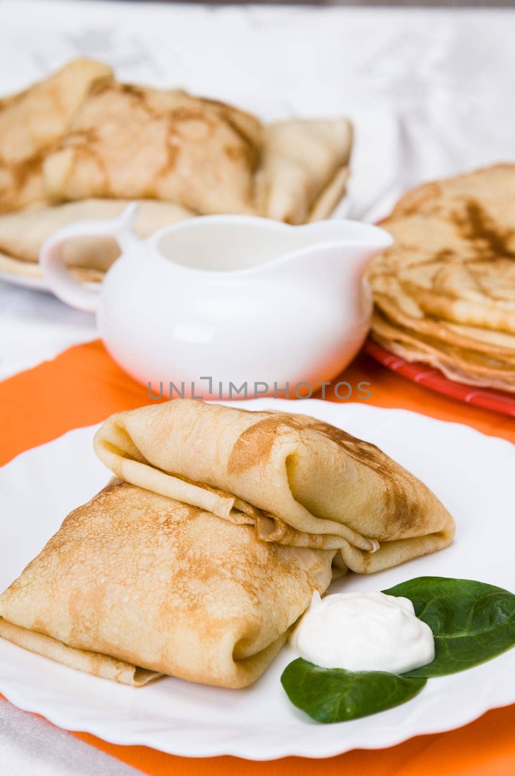 stack of pancakes with stuffing on a white plate