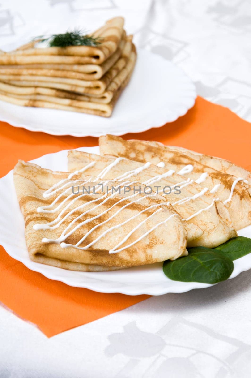 a stack of russian pancakes on a white plate
