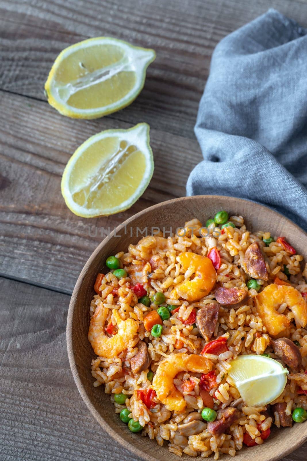 Bowl of chicken and chorizo paella with lemon wedge