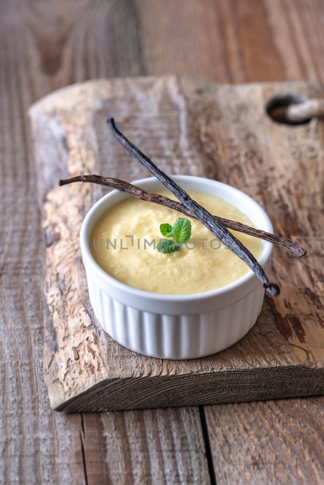 Custard decorated with mint and vanilla pods
