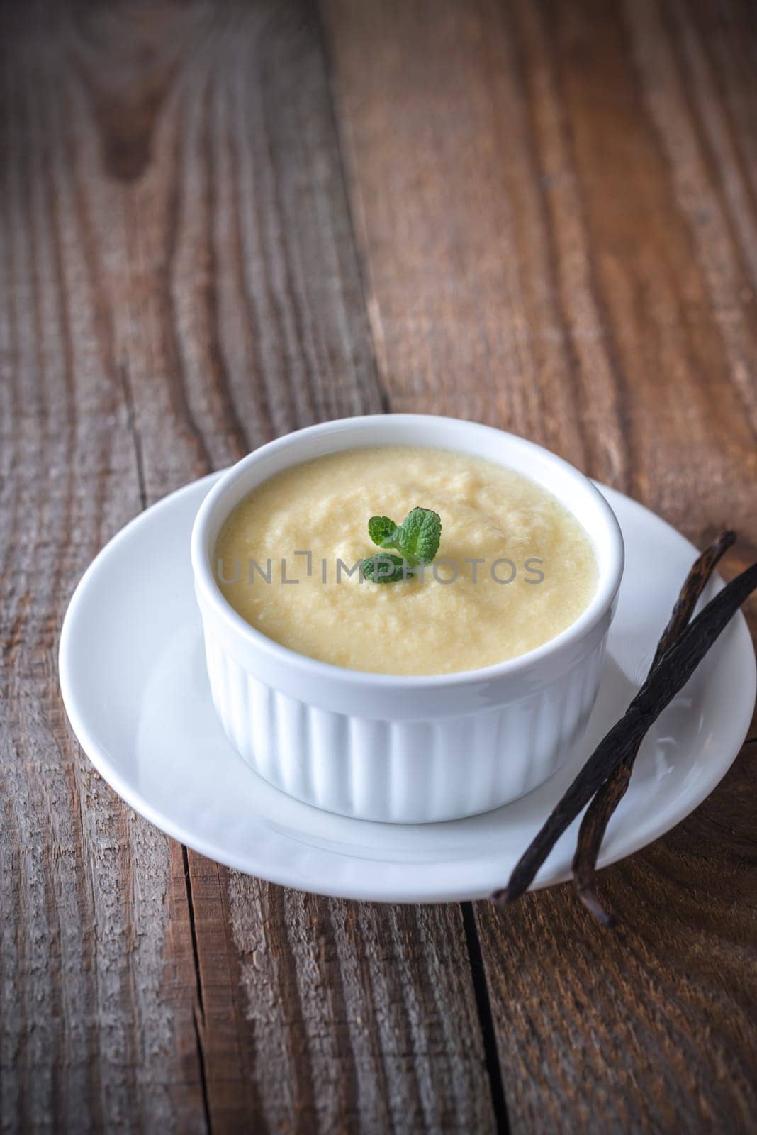 Custard decorated with mint and vanilla pods
