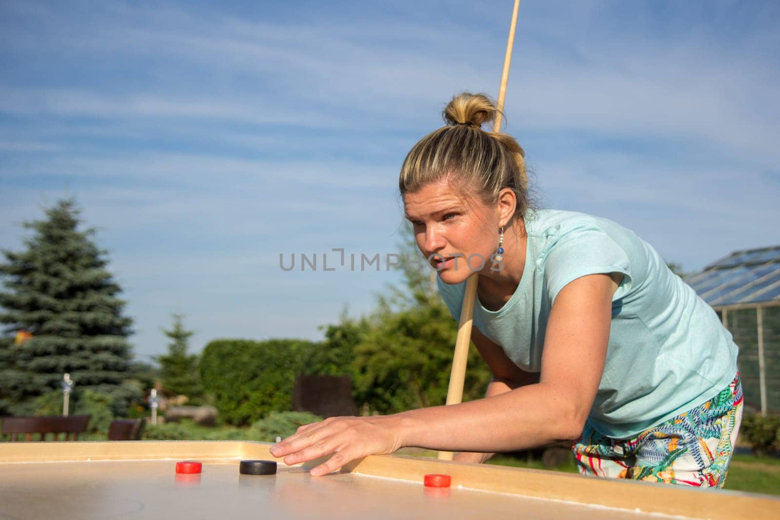 Women playing Novuss in outdoors. Novuss is a national sport in Latvia similar to pocket billiards or pool.