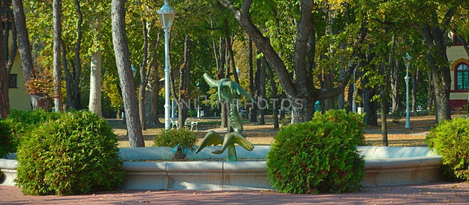 Public park with fountain and statue in the middle