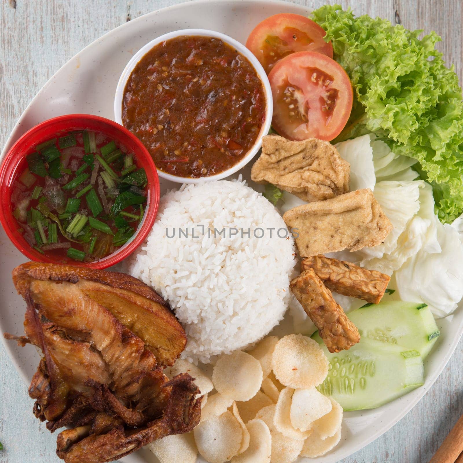 Nasi lemak kukus with fried chicken, popular traditional Malaysian local food. Flat lay top down overhead view.