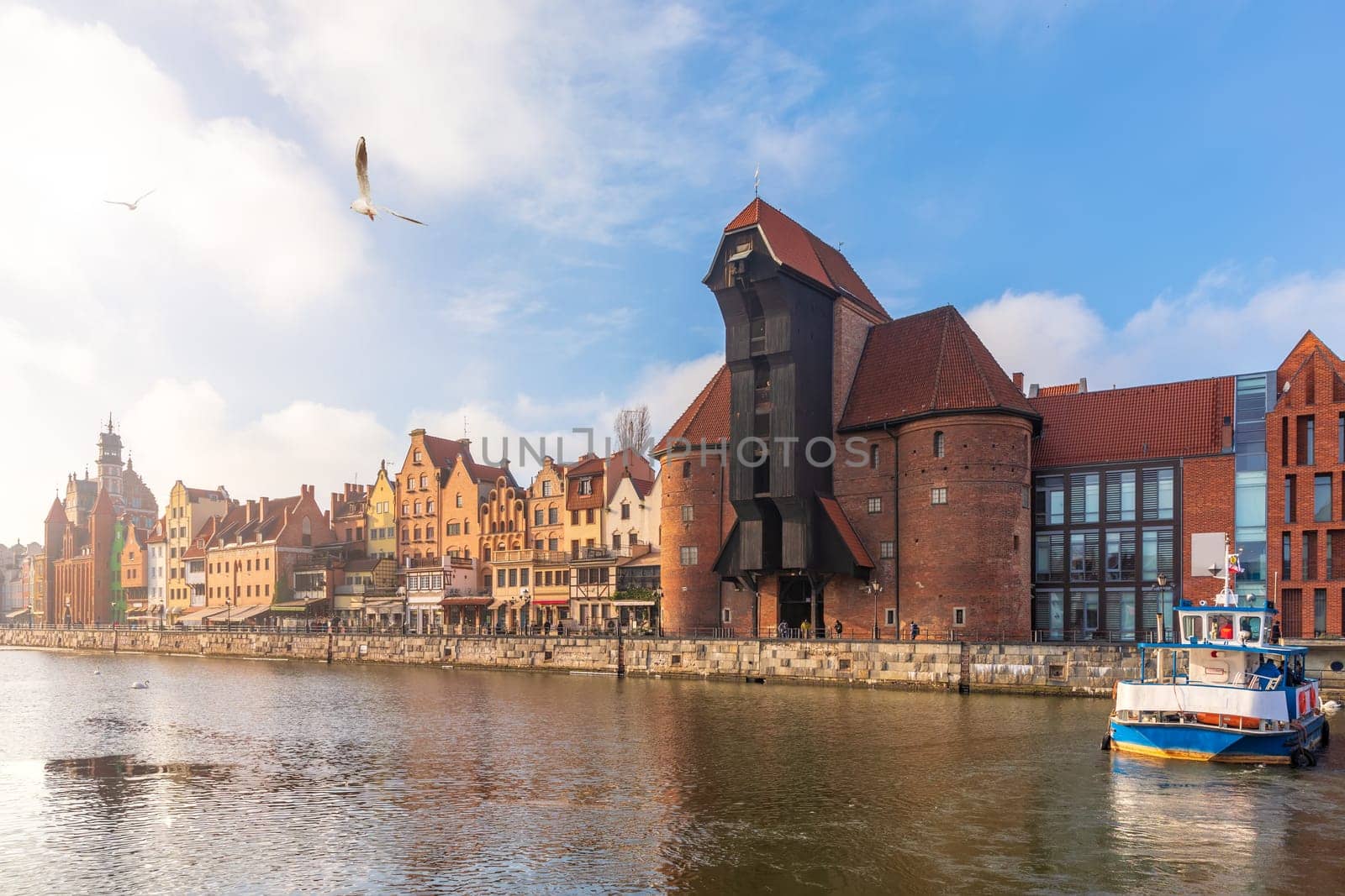 Zuraw Port Crane and the Motlawa embankment in Gdansk, sunny weather.
