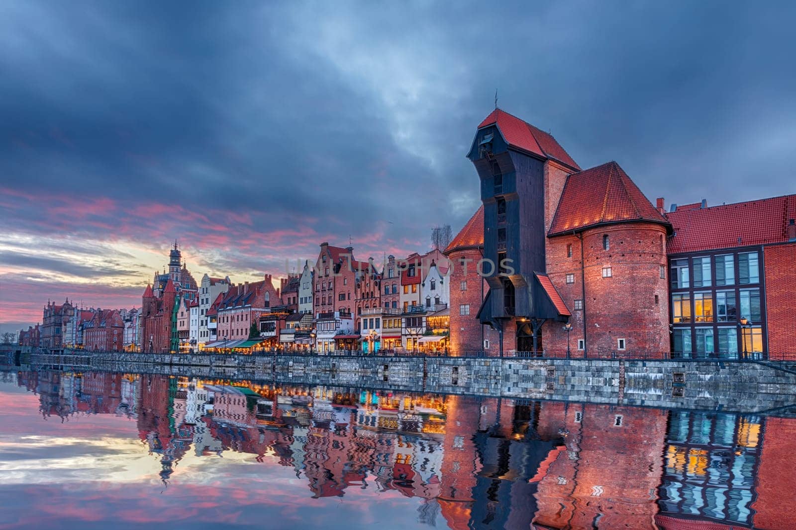 Gdansk beautiful sunset, view on Zuraw port crane and medieval facades, Poland.