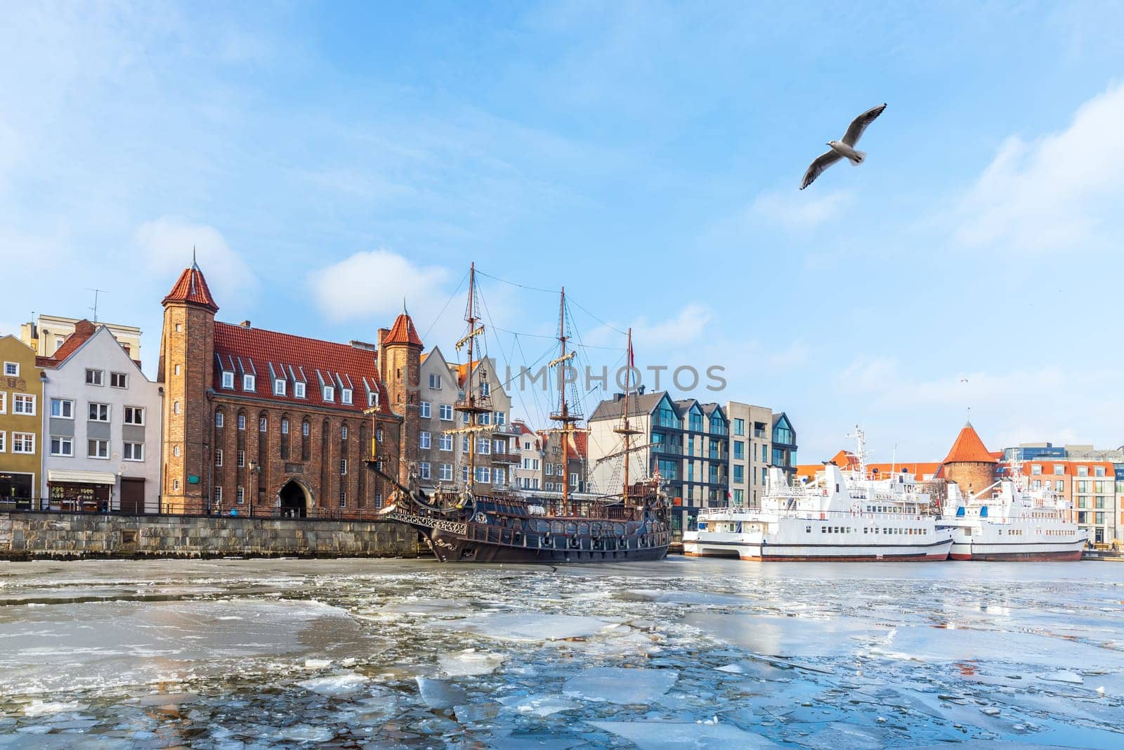 Winter Motlawa river in Gdansk, view on the Mariacka Gate and the ships.