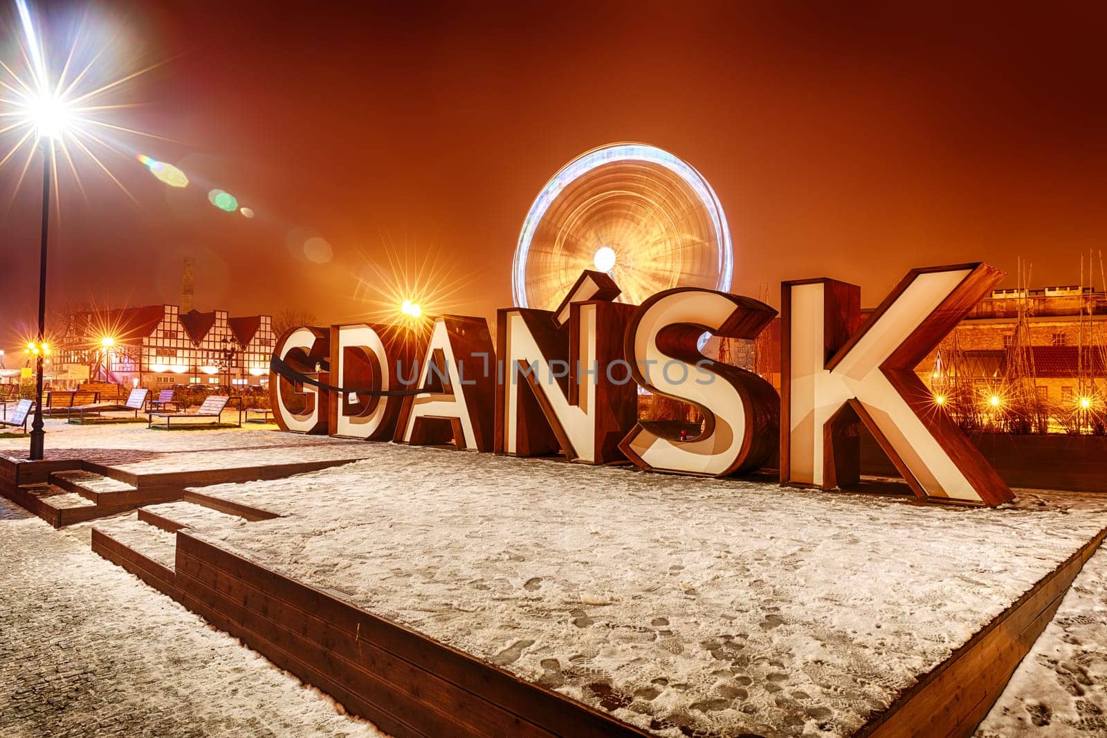 Gdansk inscription and the ferris wheel in night lights, winter view, Poland.