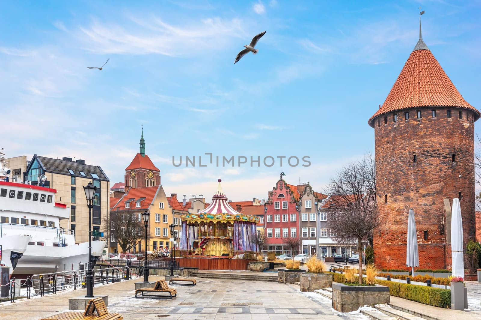 Swan Tower, the Dome of the Church and the carrousel on the bank of the Motlawa in Gdansk, Poland.