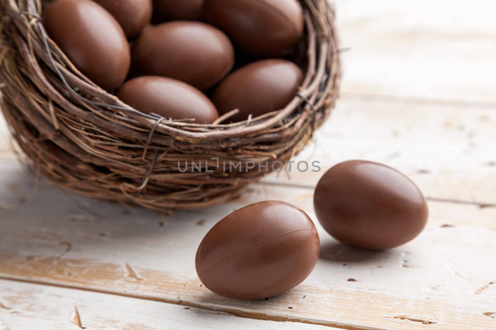 Delicious chocolate Easter holiday egg on rustic background