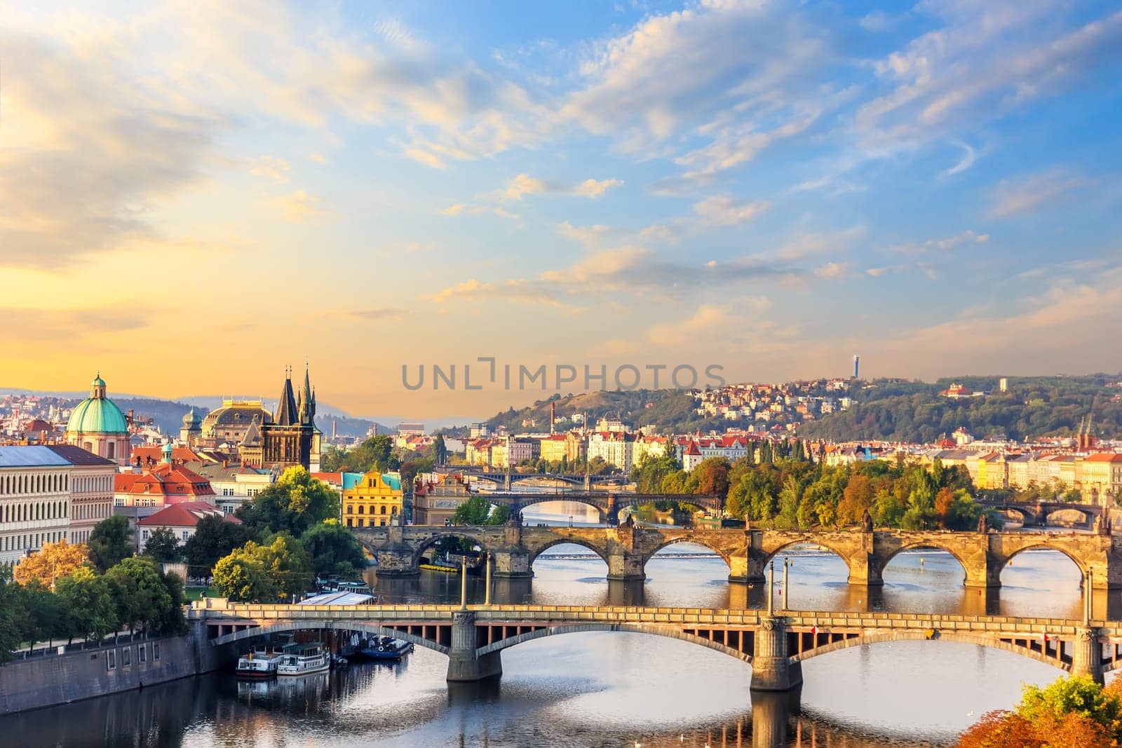 Charles Bridge and other bridges over the Vltava river and the Old Town of Prague view at sunrise.
