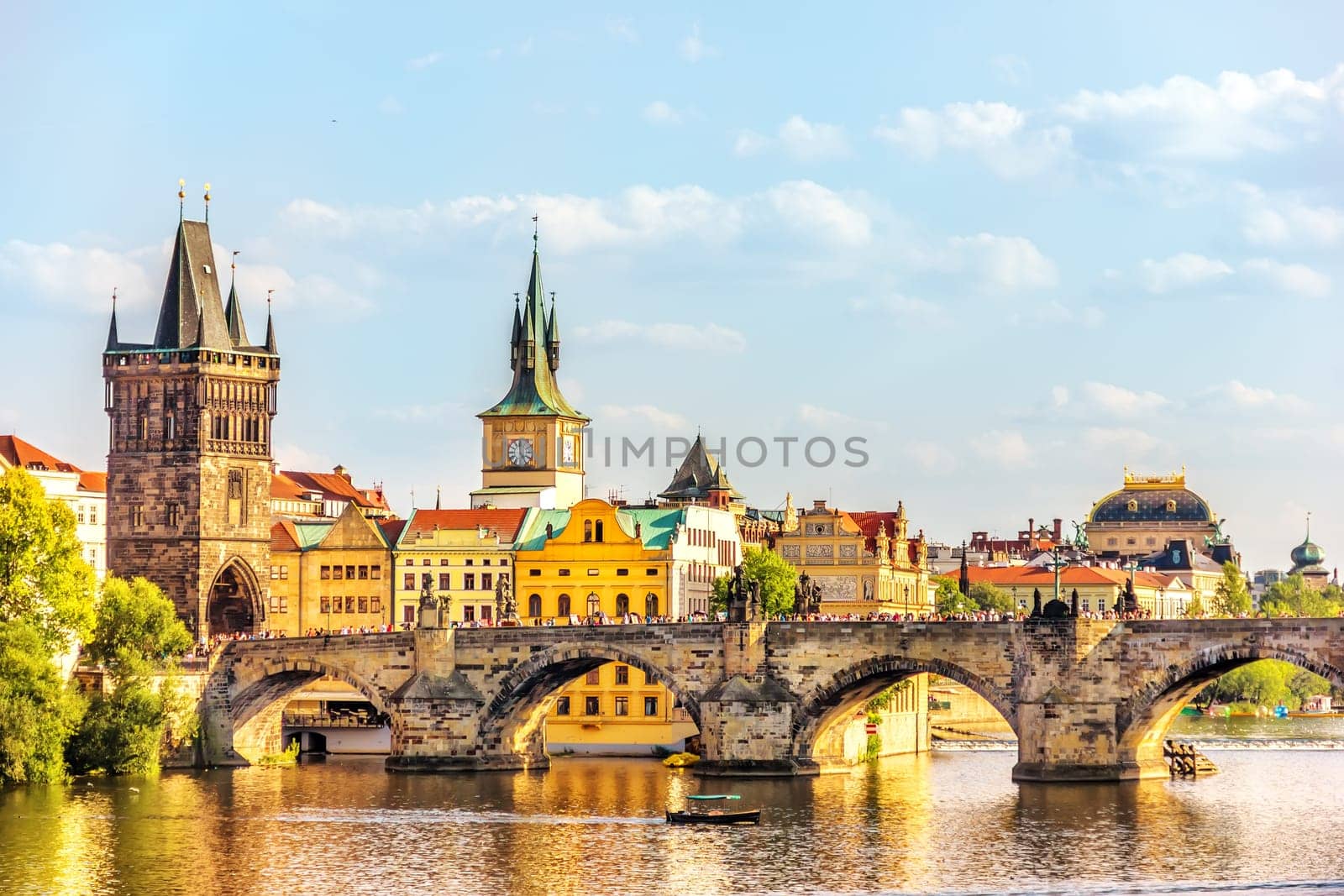 Charles Bridge, Prague towers and the National Theatre, summer day view.