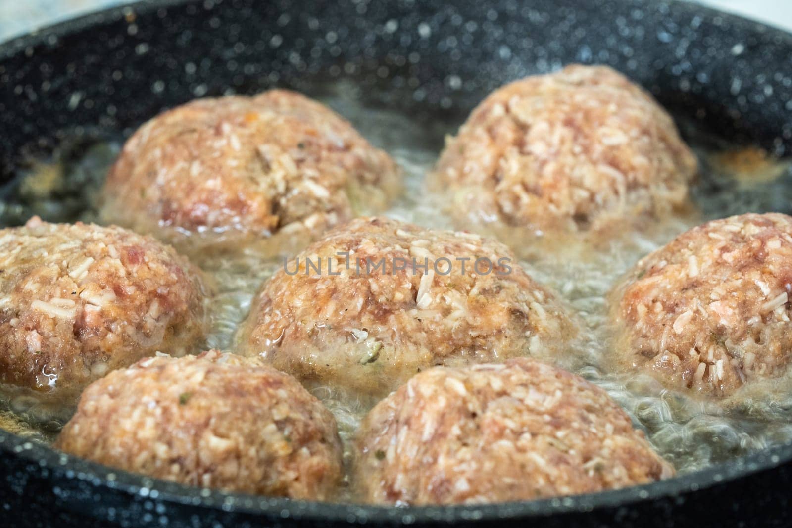 Fried burgers in the pan. Frying food in the oil.